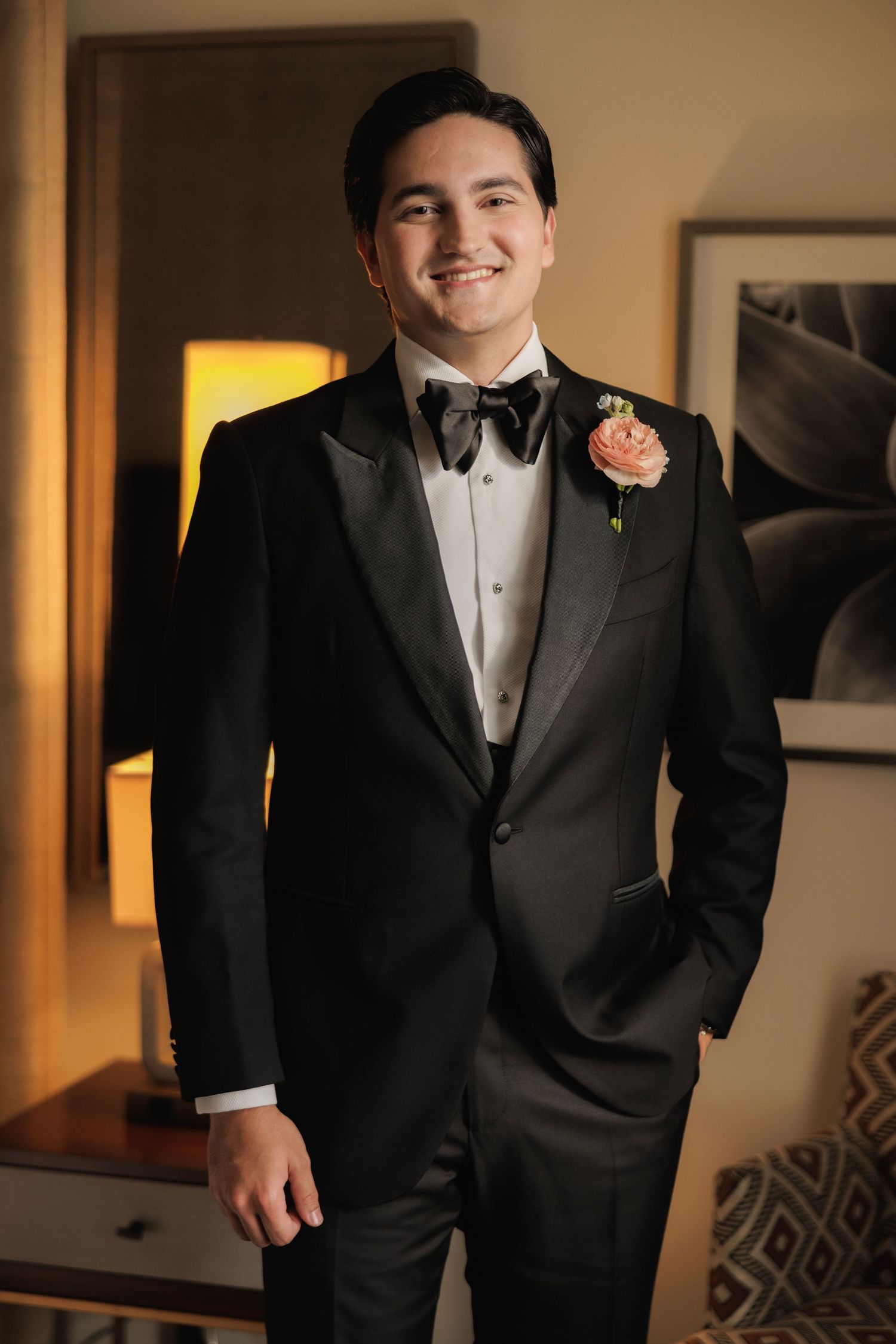 A series of photos showing a groom in a classic black tuxedo with bowtie and boutonniere.