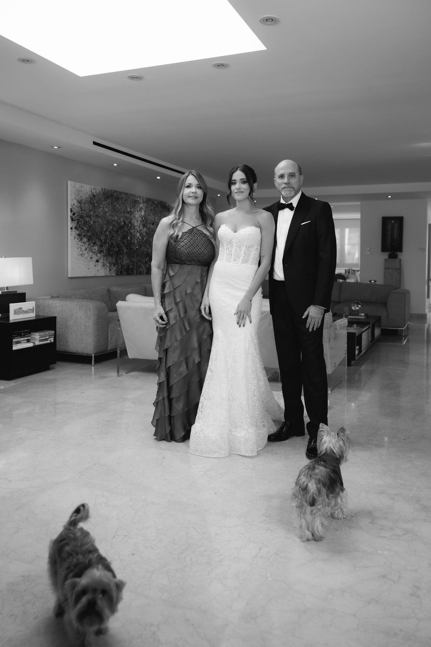 Black and white wedding scene with small dog joining the formal occasion.