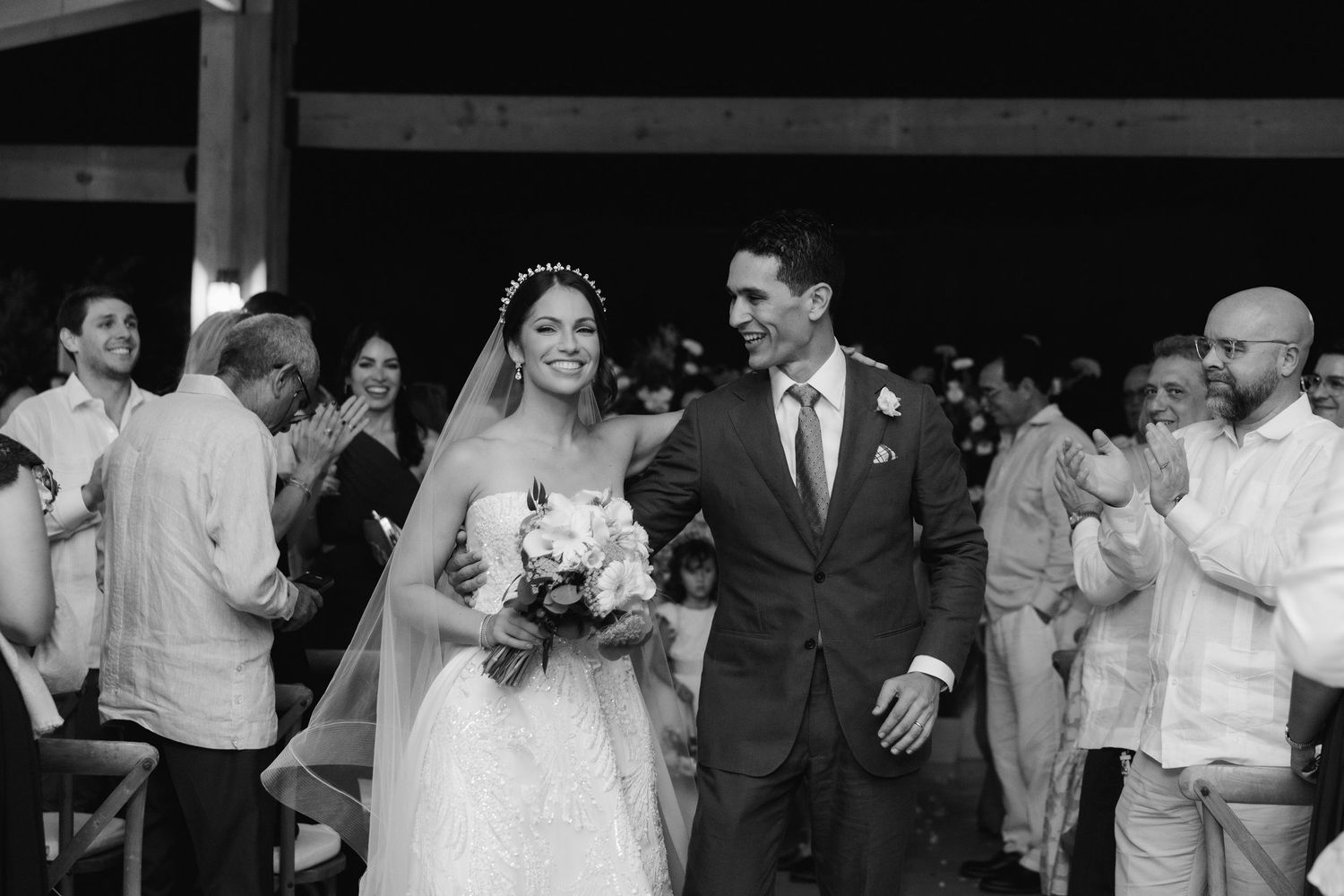Black and white wedding celebration photos capturing joyful moments with guests.