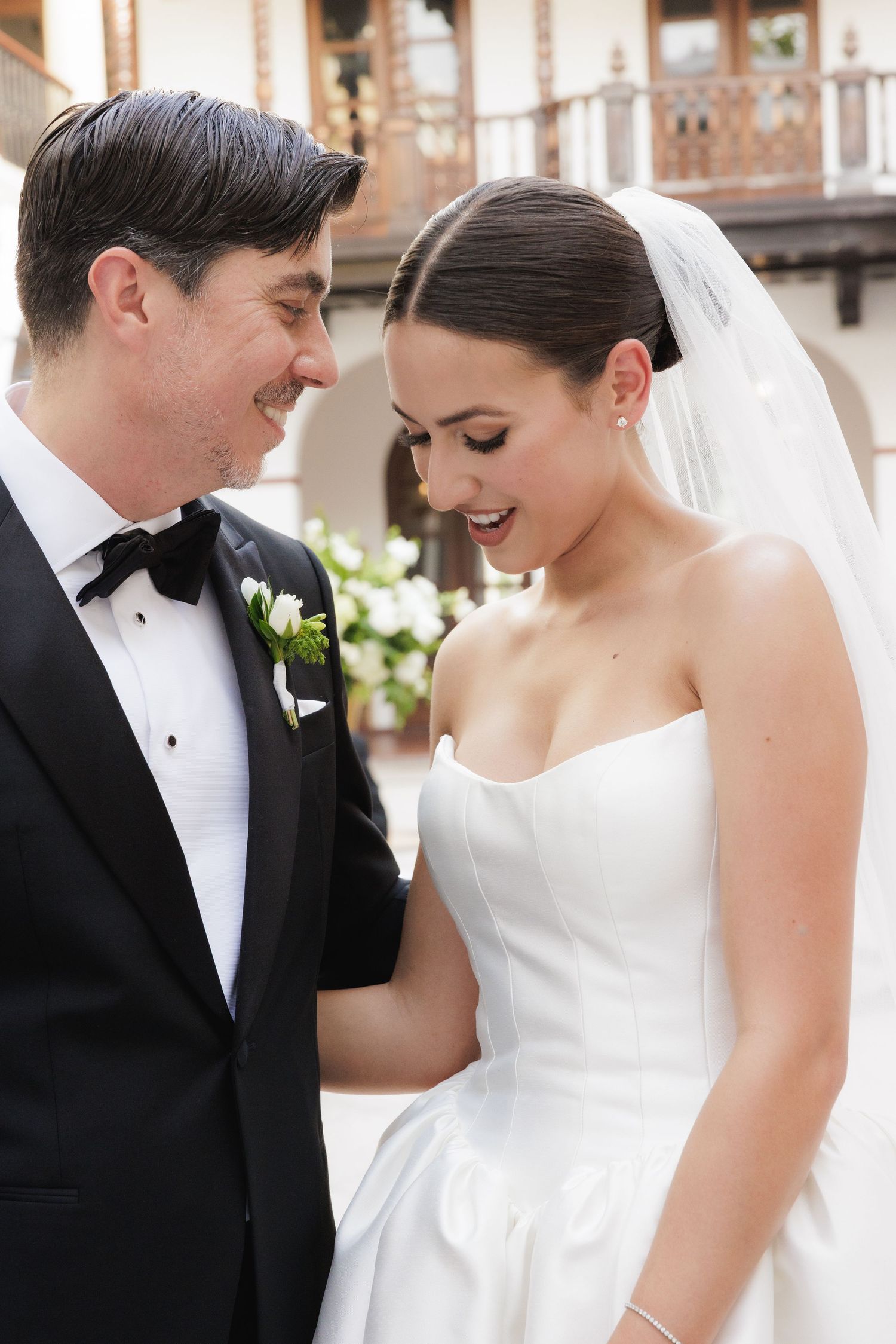 Intimate wedding portrait showing tender moment between newlyweds at elegant venue.