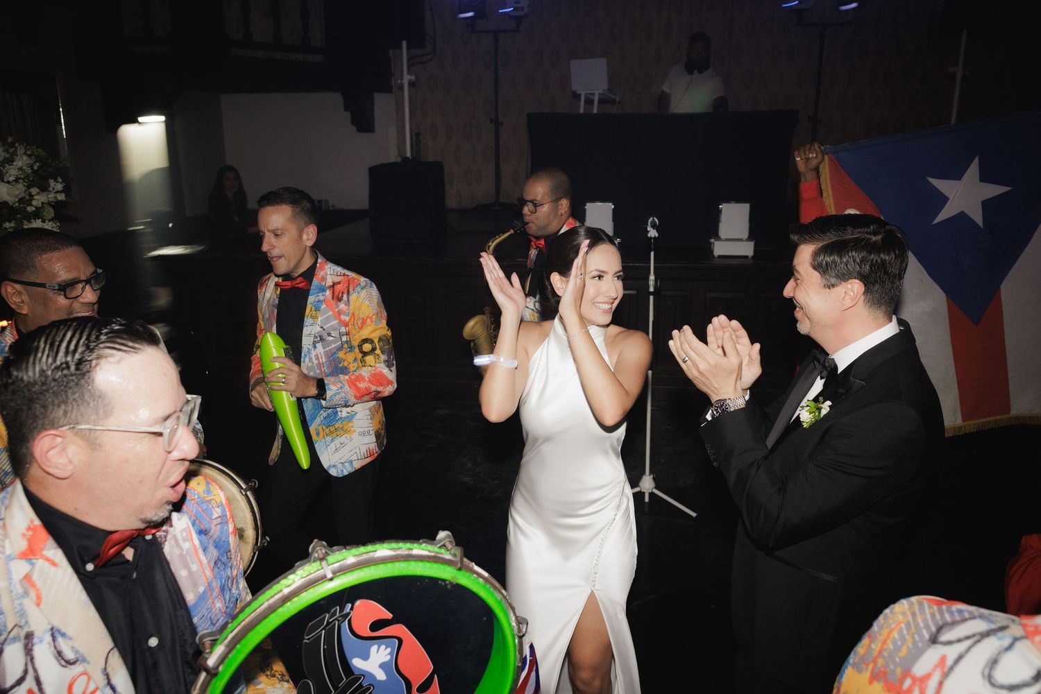 Wedding reception dance party with colorful lighting and energetic guests.