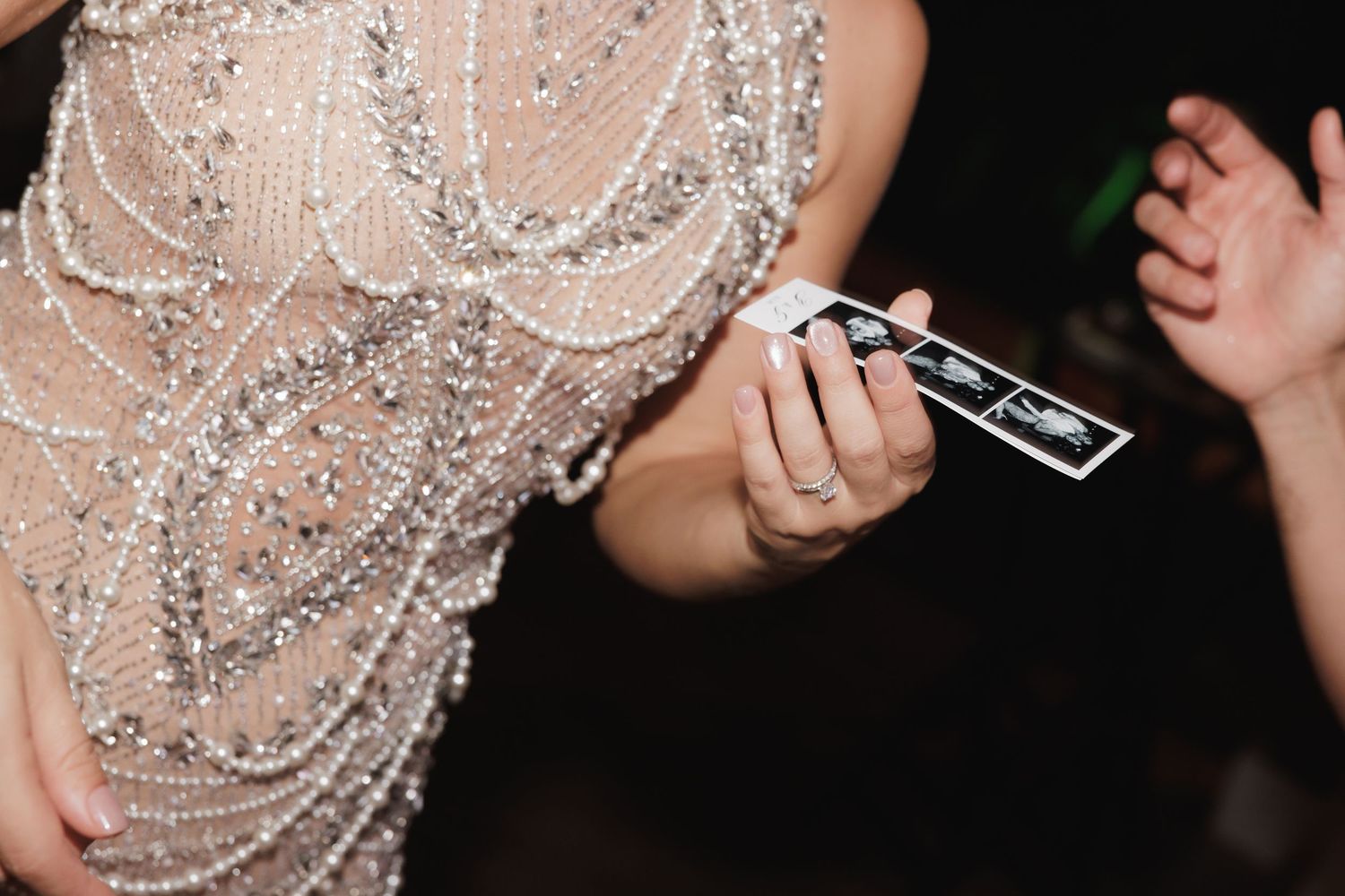 Close-up of a sparkly beaded dress detail at a formal event.