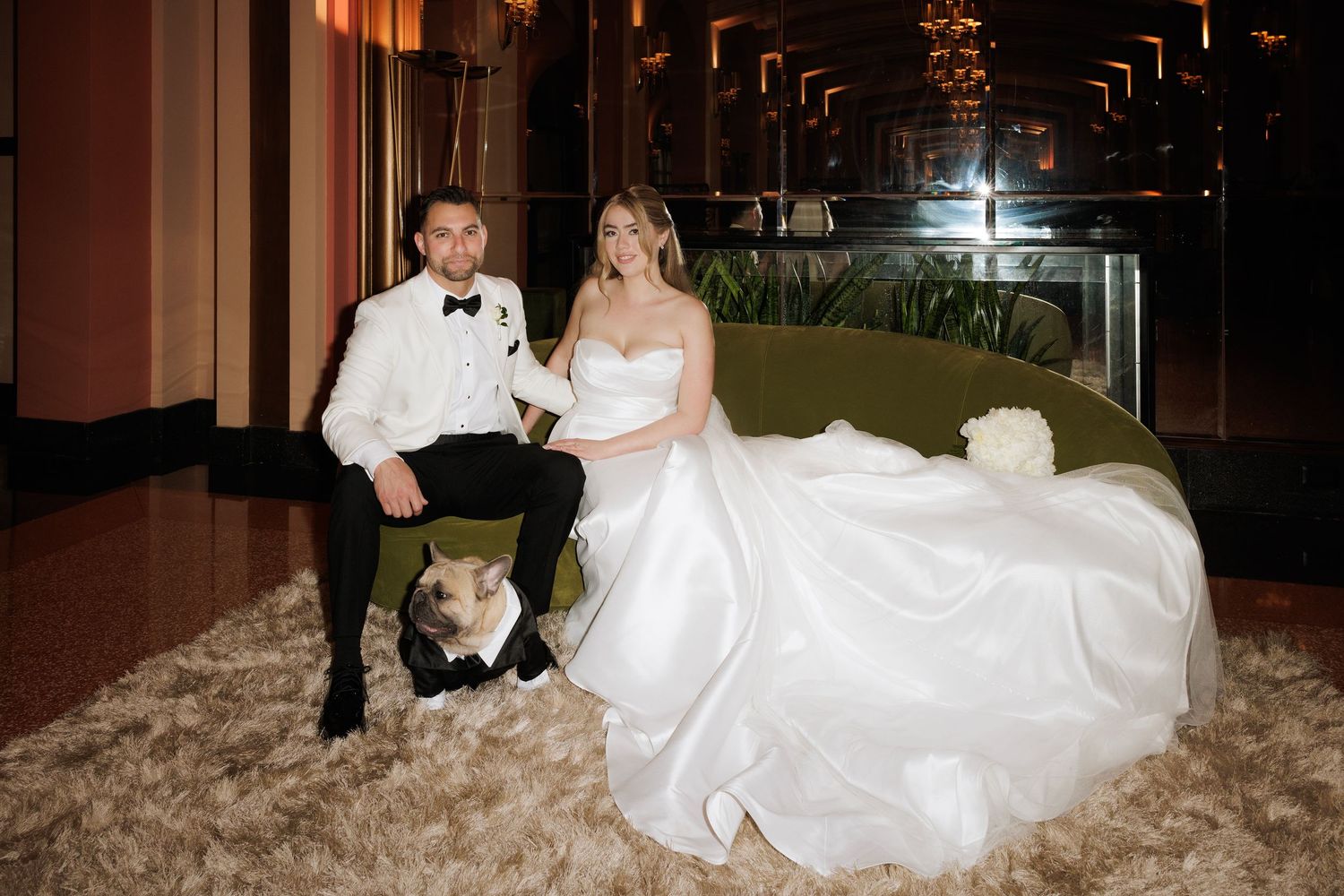 A wedding couple poses in a series of romantic shots at their reception venue with elegant decor and lighting.