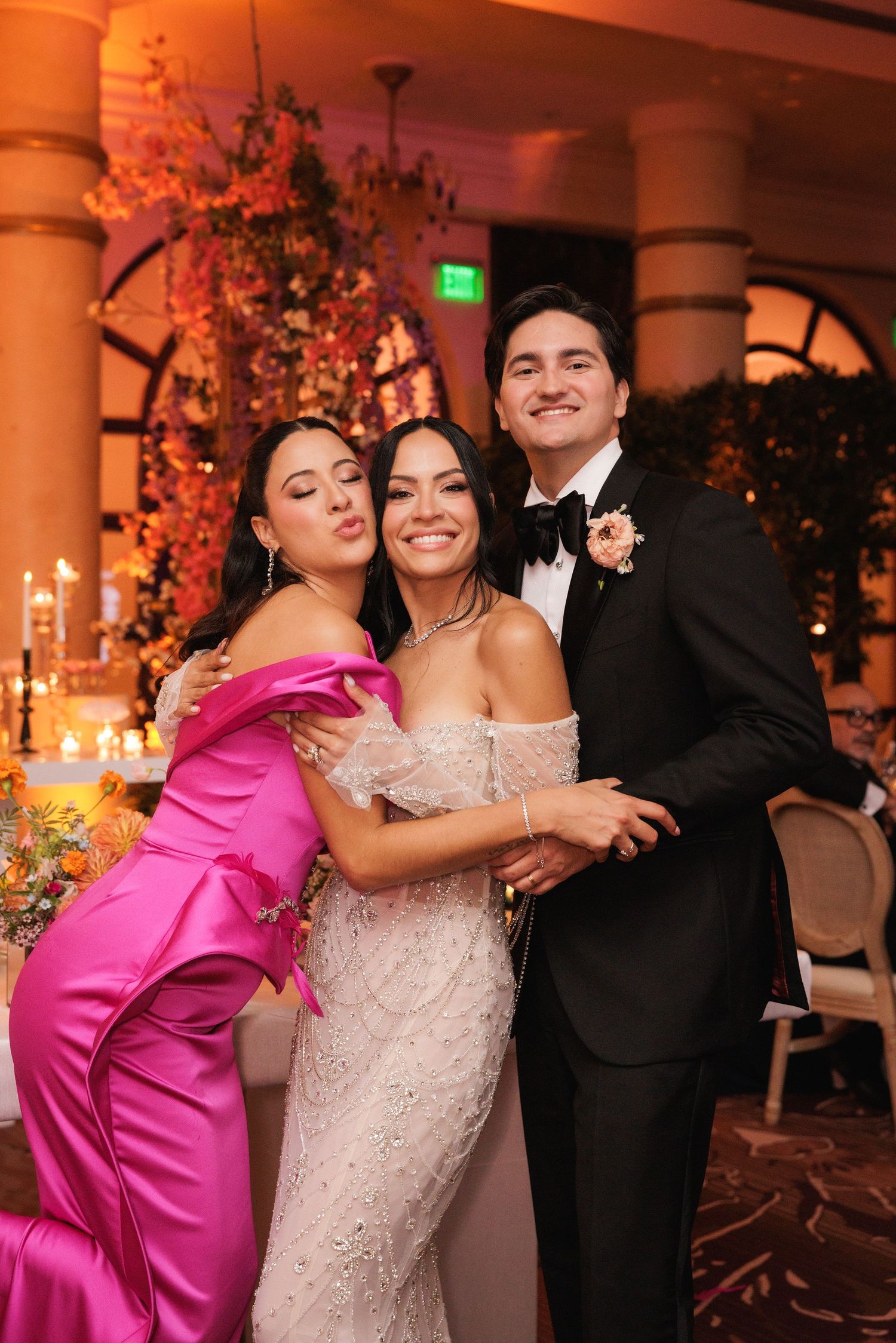 A series of candid celebration photos at an elegant wedding reception with bridesmaids in bright pink dresses.