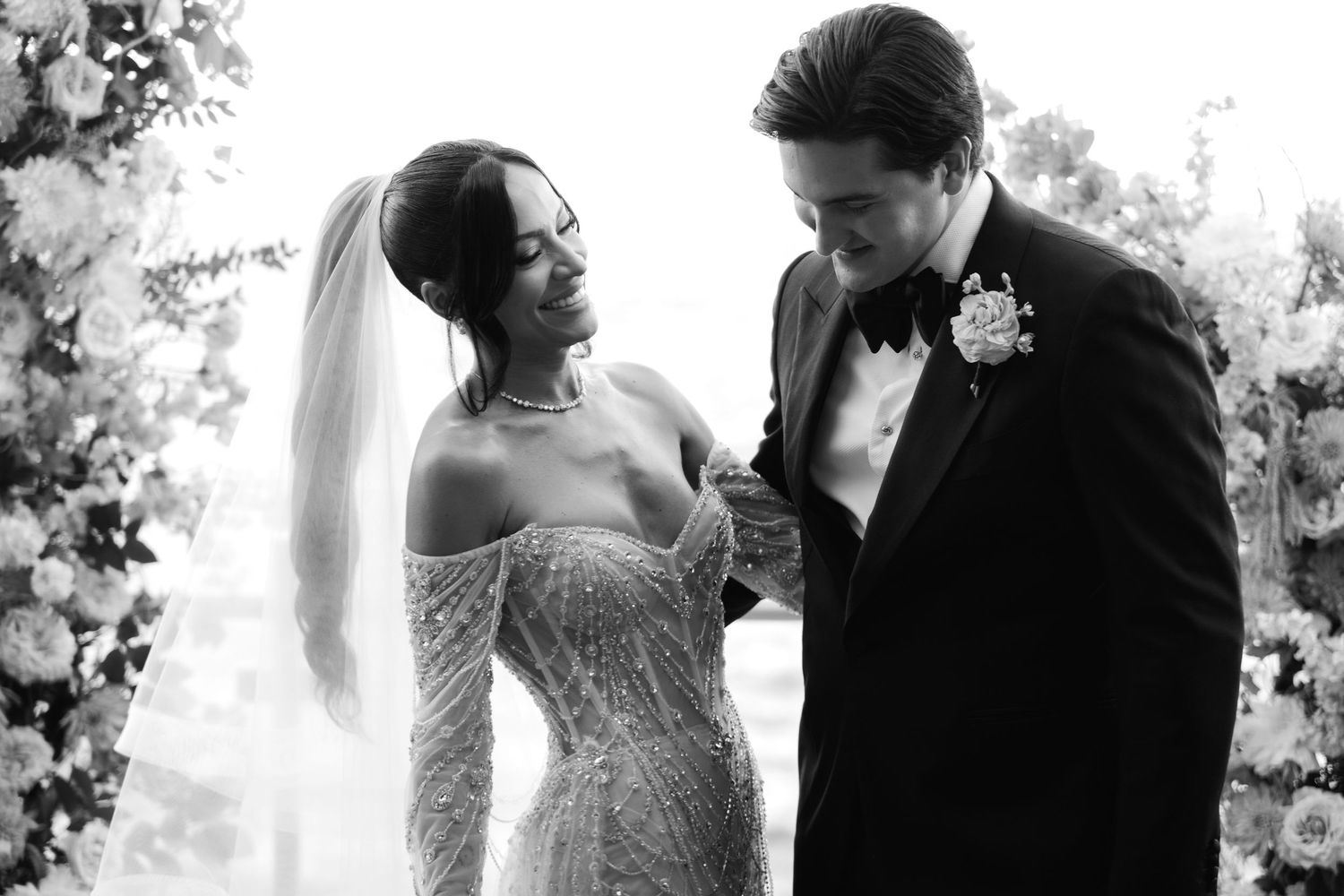 A bride and groom share romantic moments in black and white wedding photography sequence.