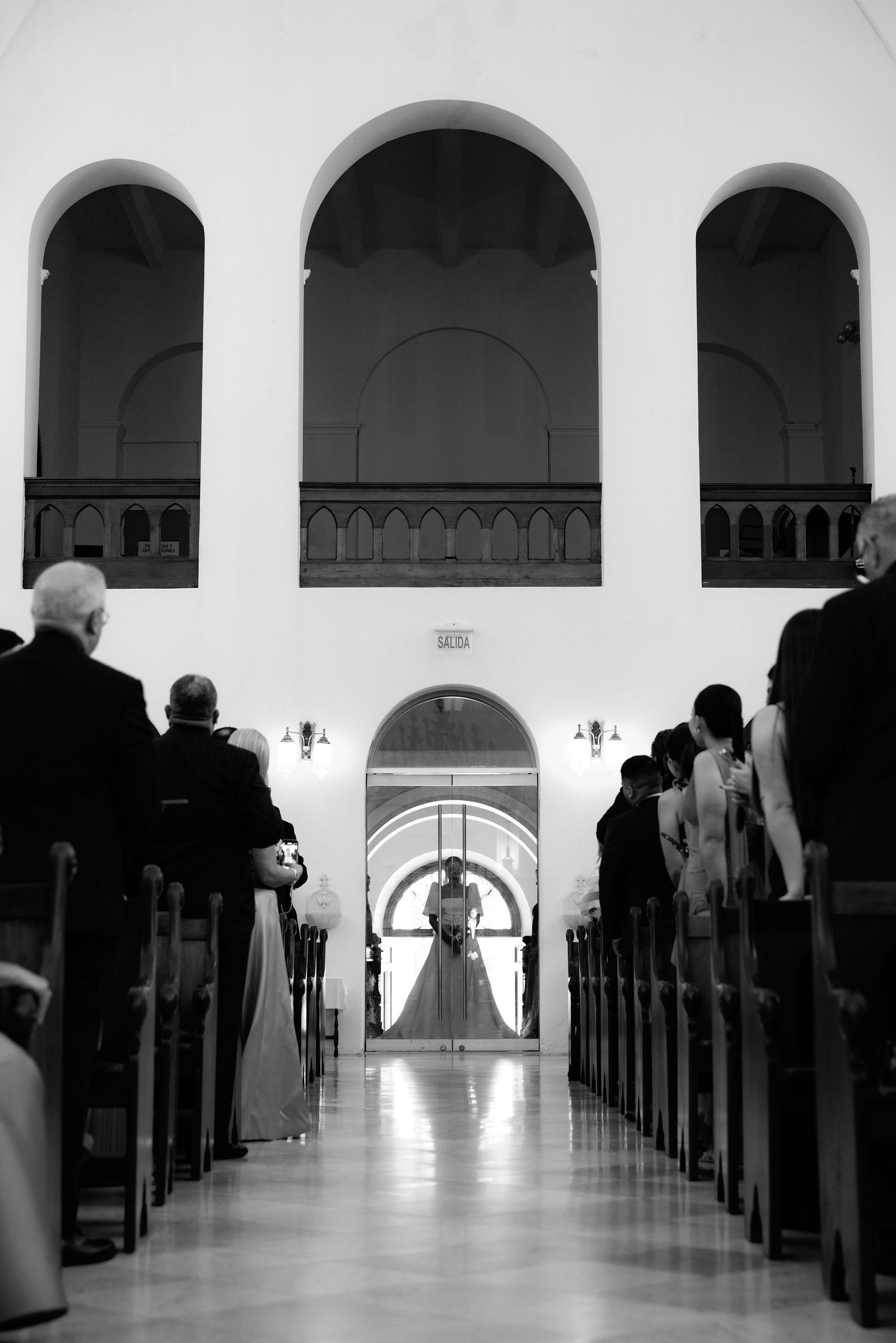 Black and white images of a church aisle with arched corridors and guests seated in pews.