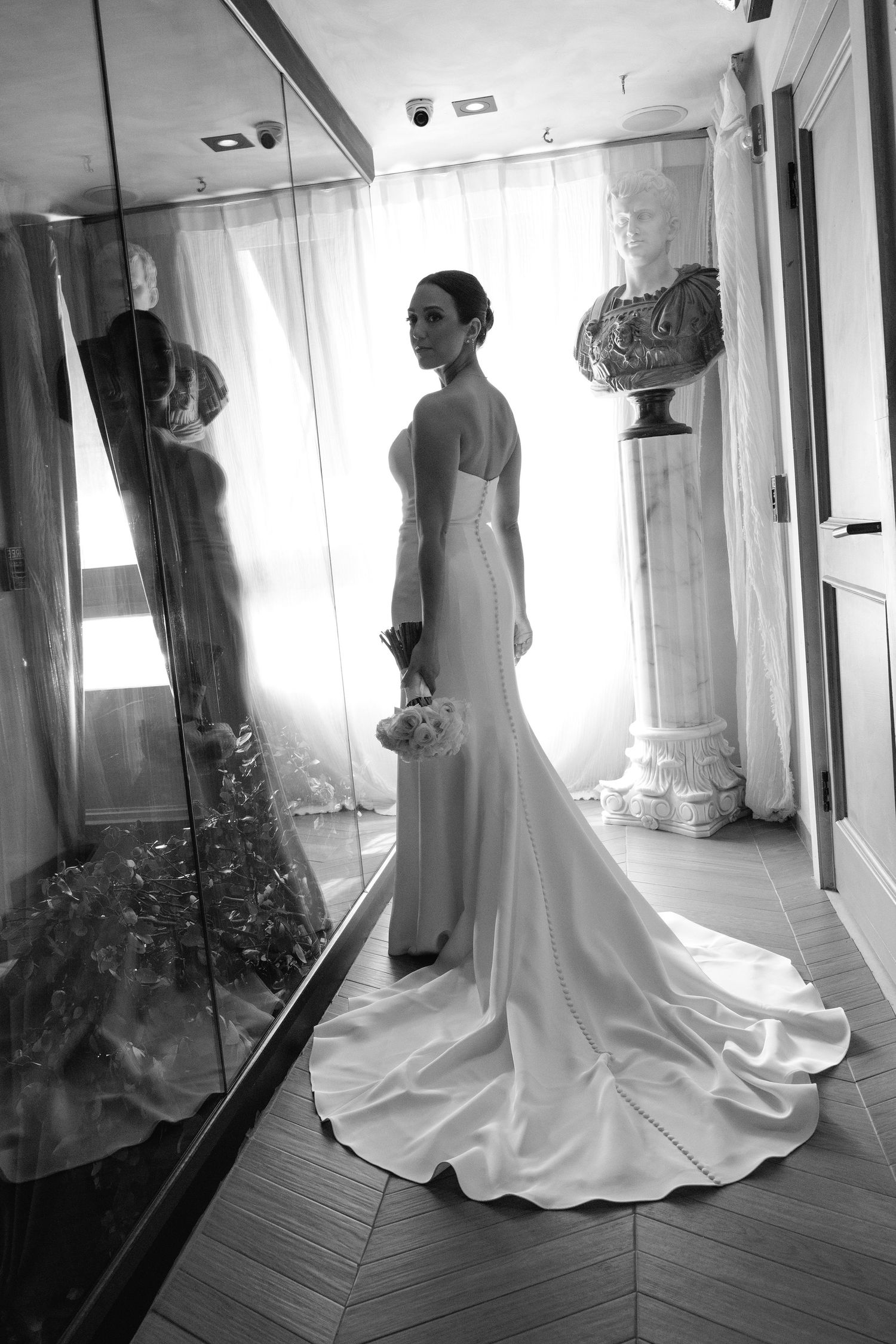 Artistic black and white photos of wedding dress reflection in mirrors of bridal suite.