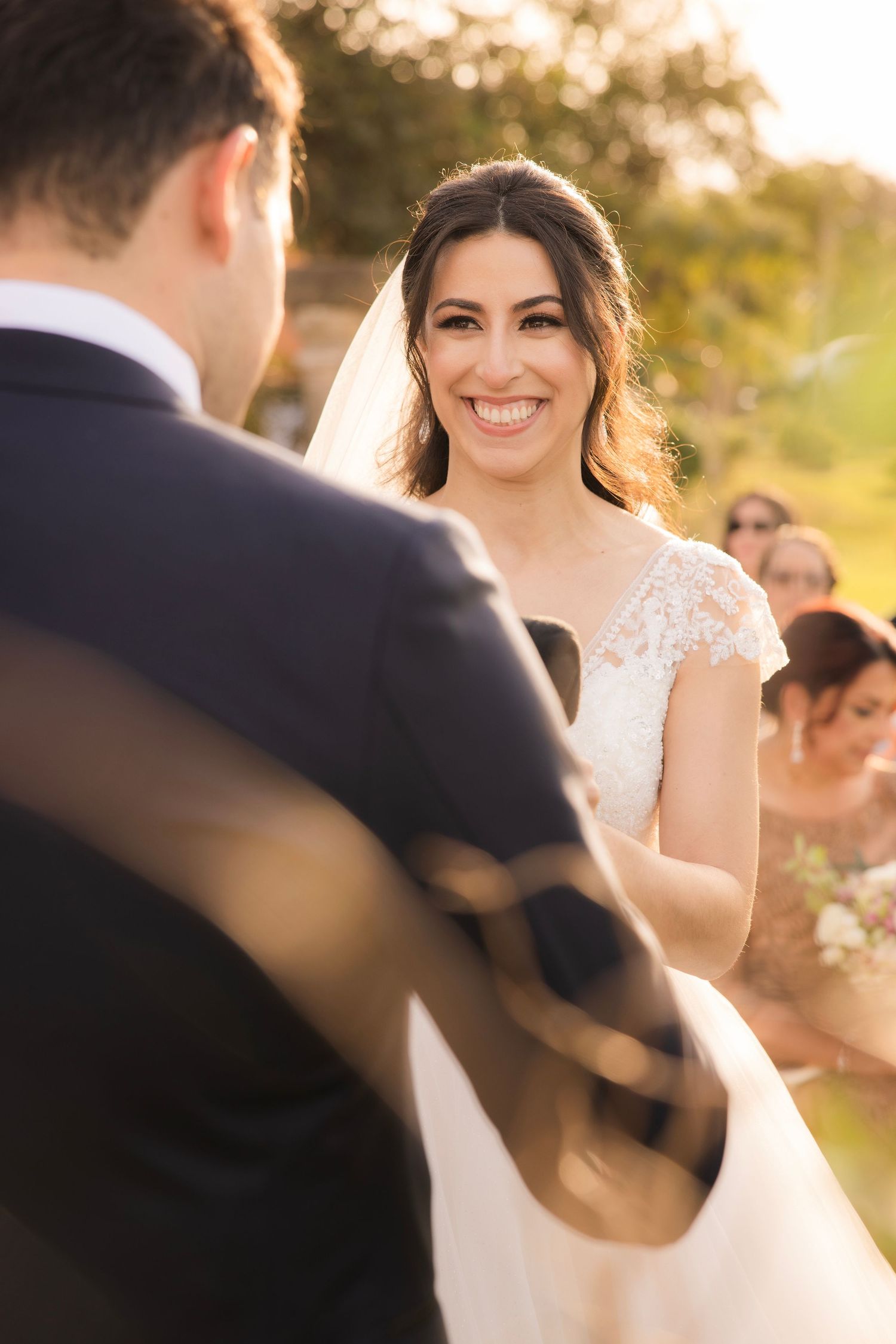 A sunlit wedding ceremony captured in warm golden hour lighting.