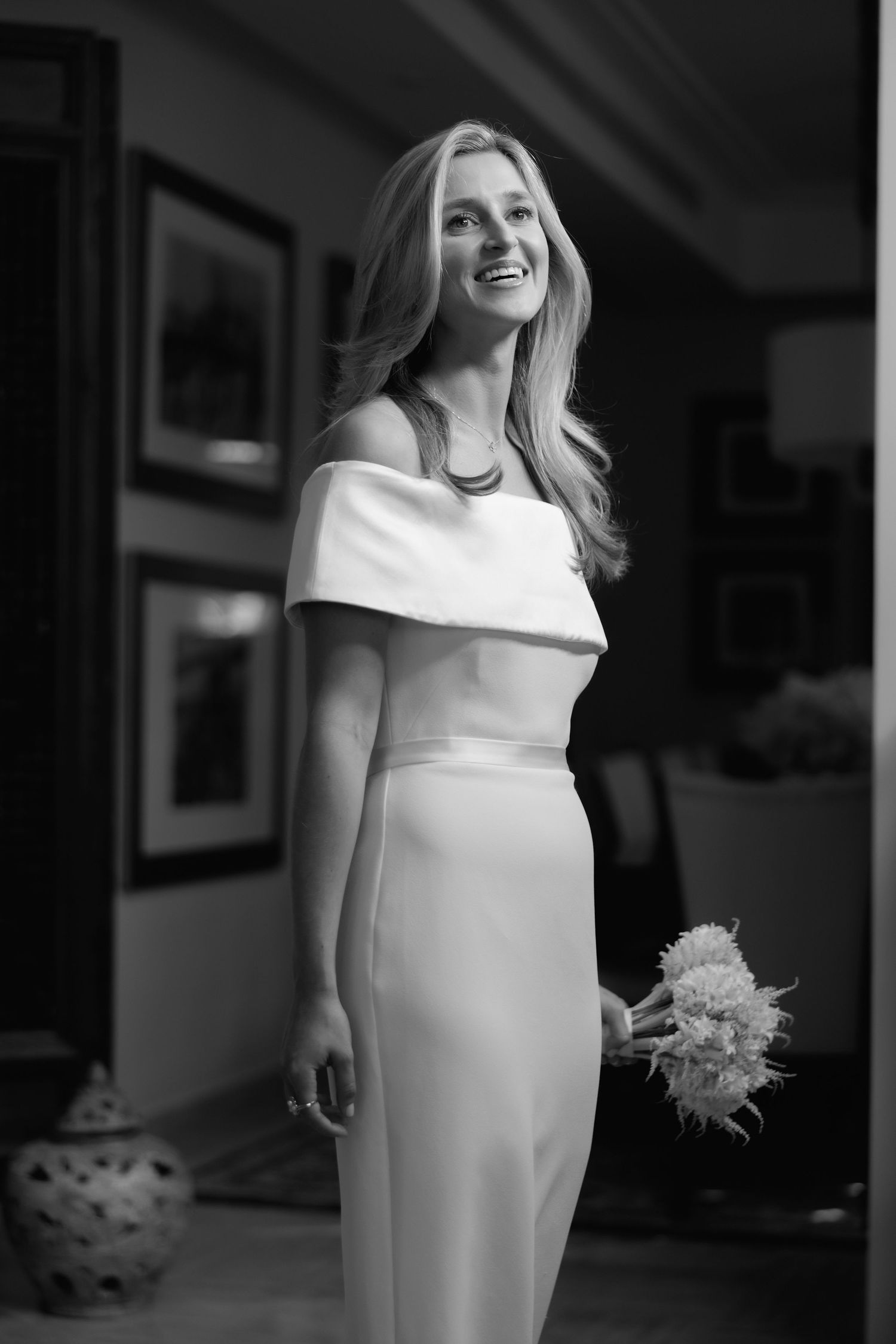 Black and white photo series showing someone in an elegant white dress holding a bouquet and posing in different angles.