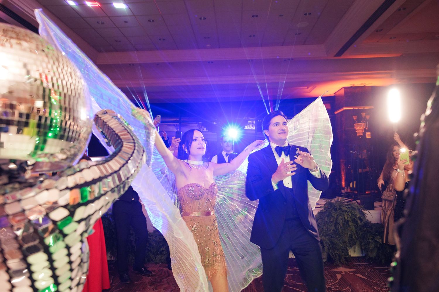 Wedding reception dance floor illuminated with purple and blue lights creating a festive party atmosphere.