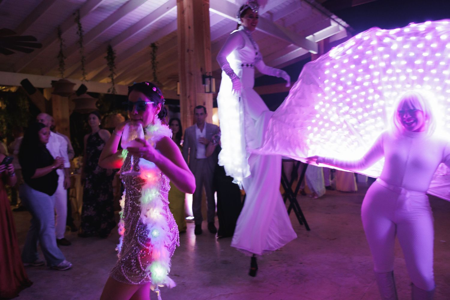 Dance party with purple lighting and illuminated decorations creating a festive atmosphere.