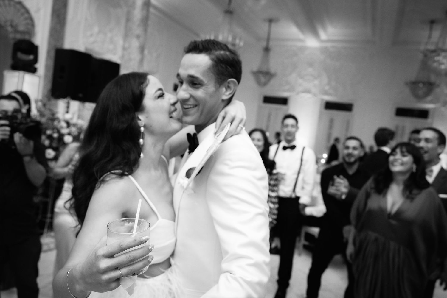 Wedding party guests dancing and celebrating together at a lively reception party.