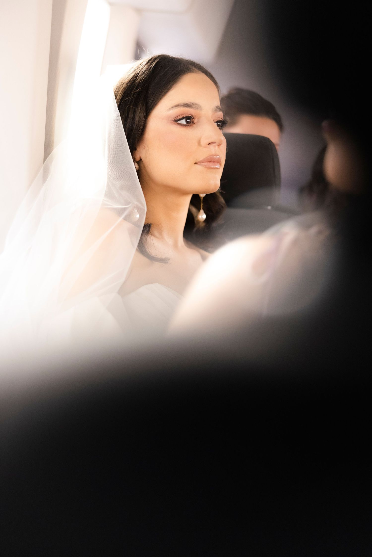 Artistic soft-focus portrait with dramatic lighting and dark vignette edges.
