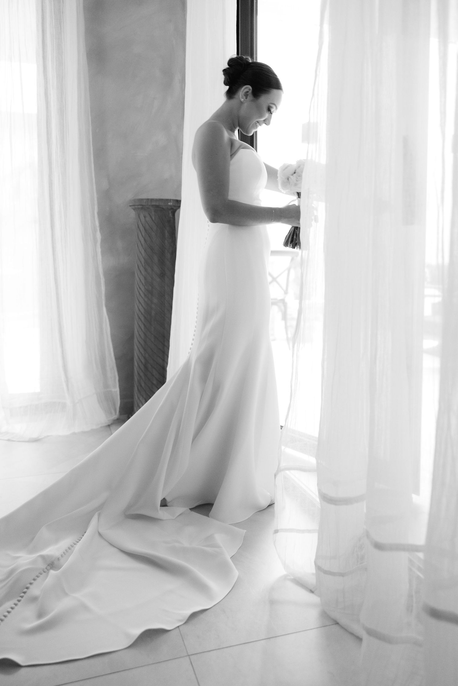 Ethereal black and white photos of a wedding dress flowing in natural light.