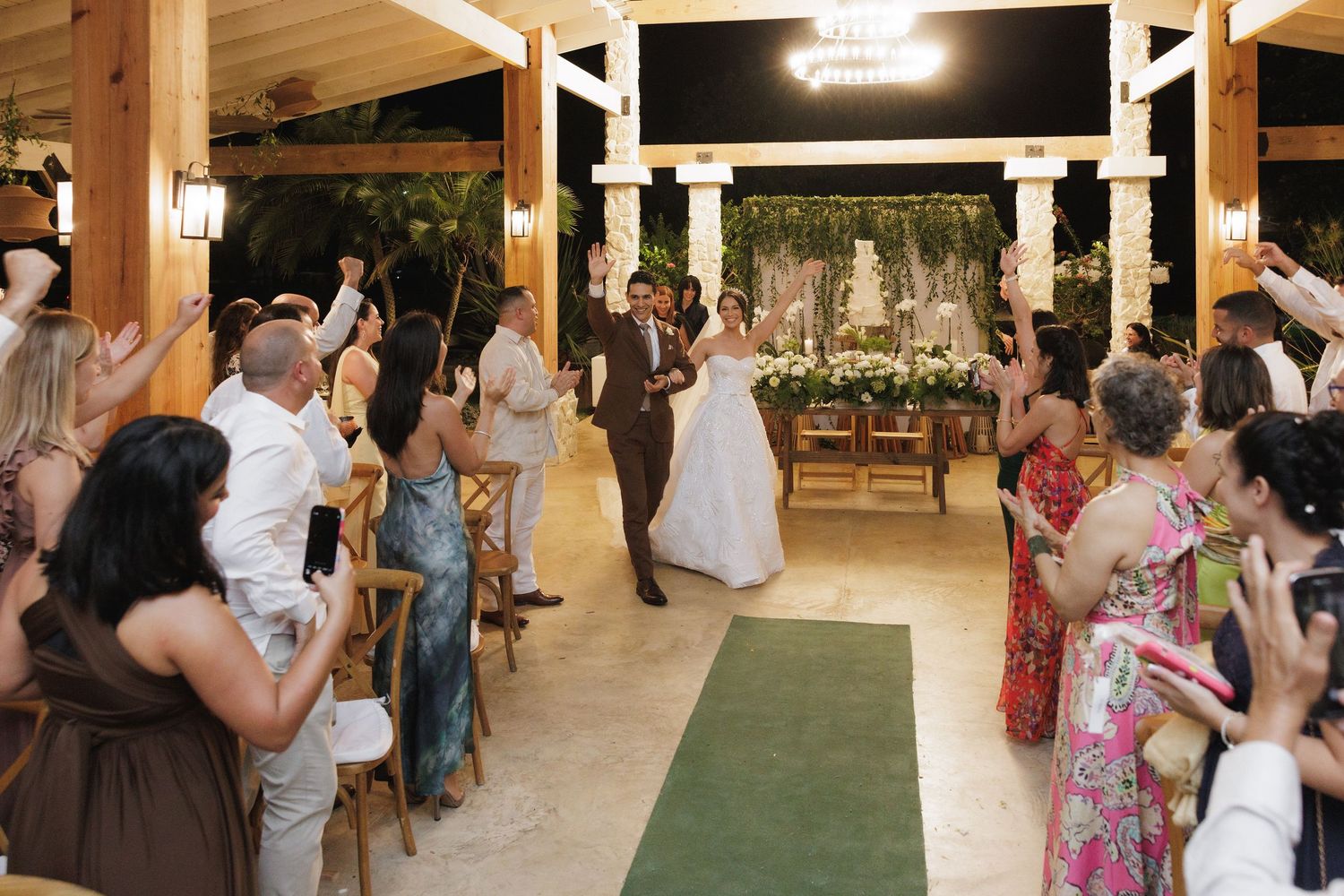 Wedding reception venue with exposed wooden beams and guests enjoying the celebration.