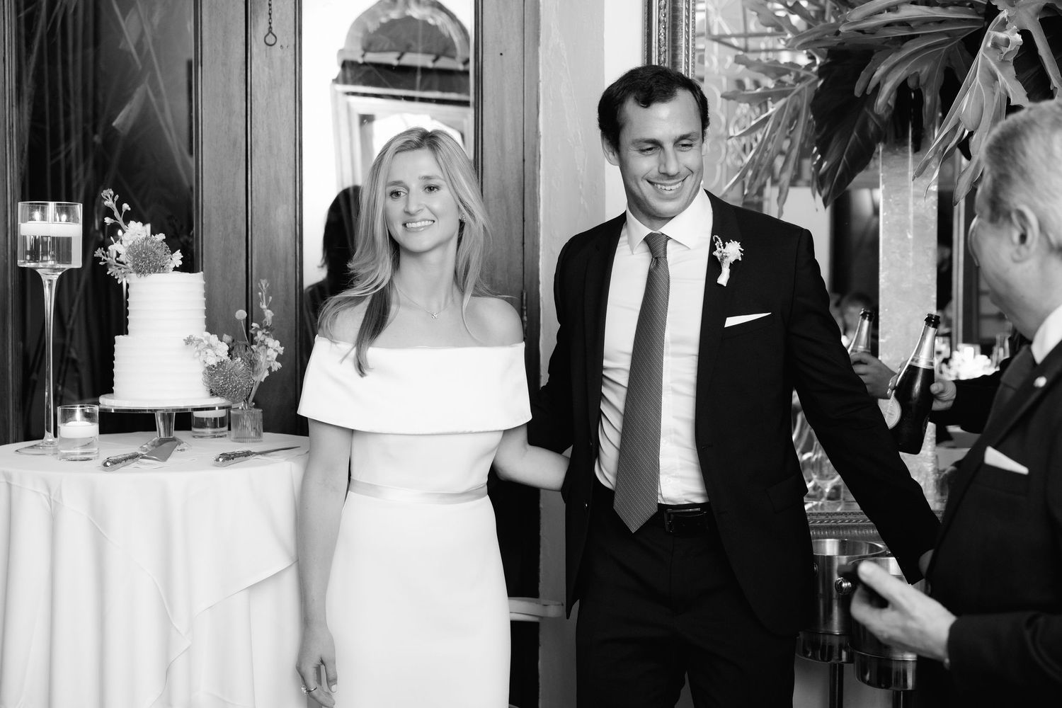 A collection of black and white wedding photographs showing candid moments, formal poses, and celebrations at a reception.