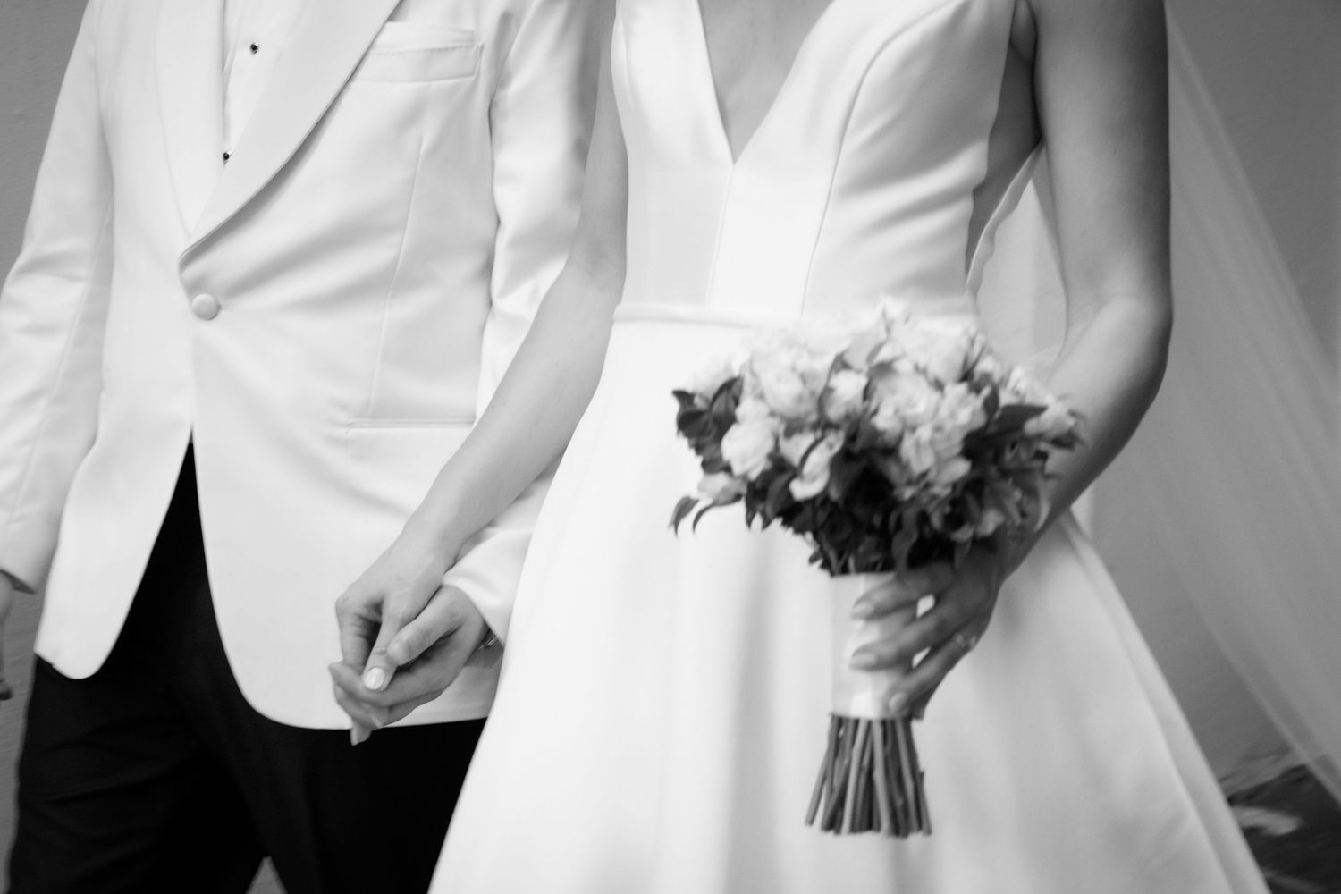 A series of black and white wedding photos showing intimate moments between a couple in formal attire.