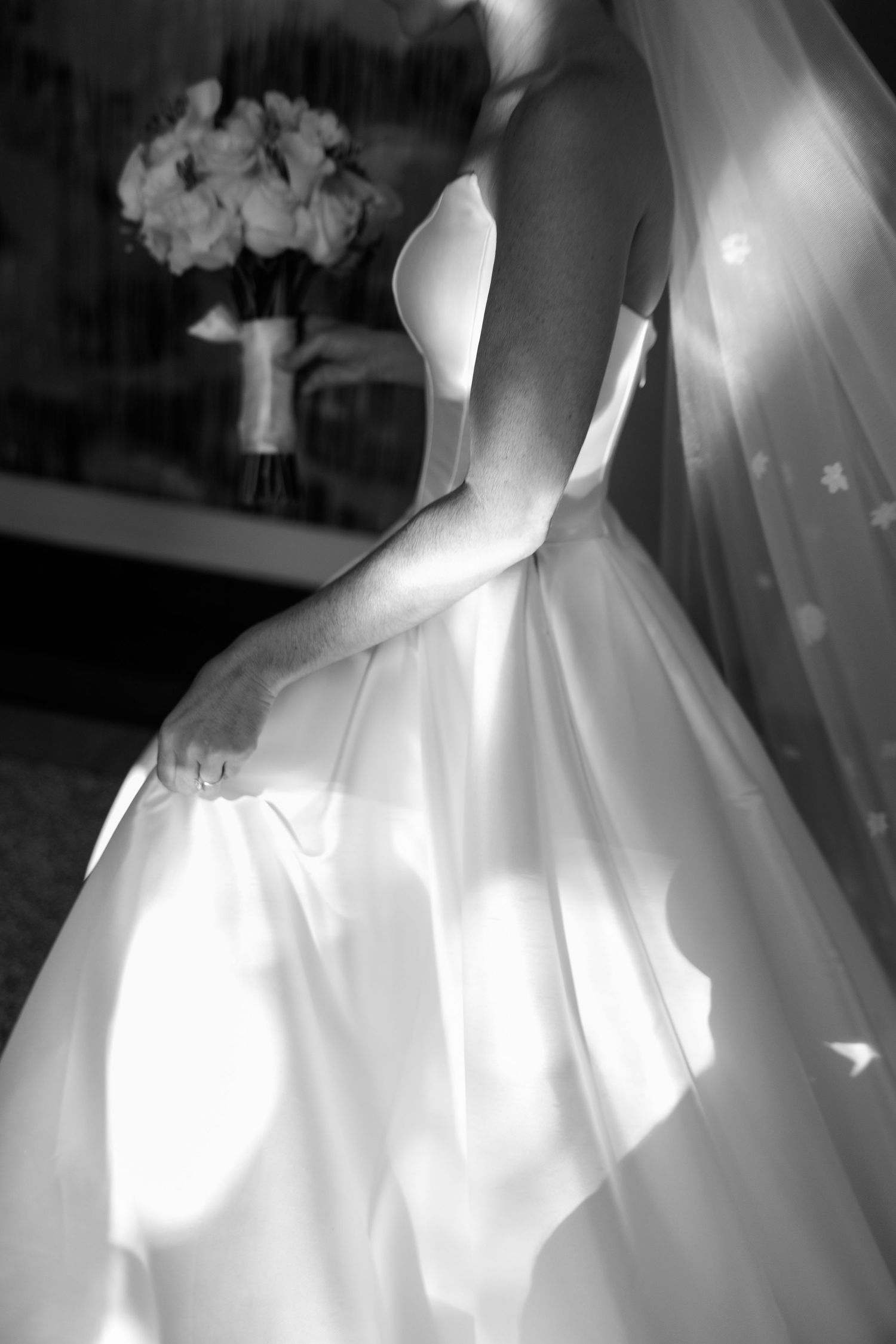 Artistic black and white close-up shots of wedding dress details and silhouette.