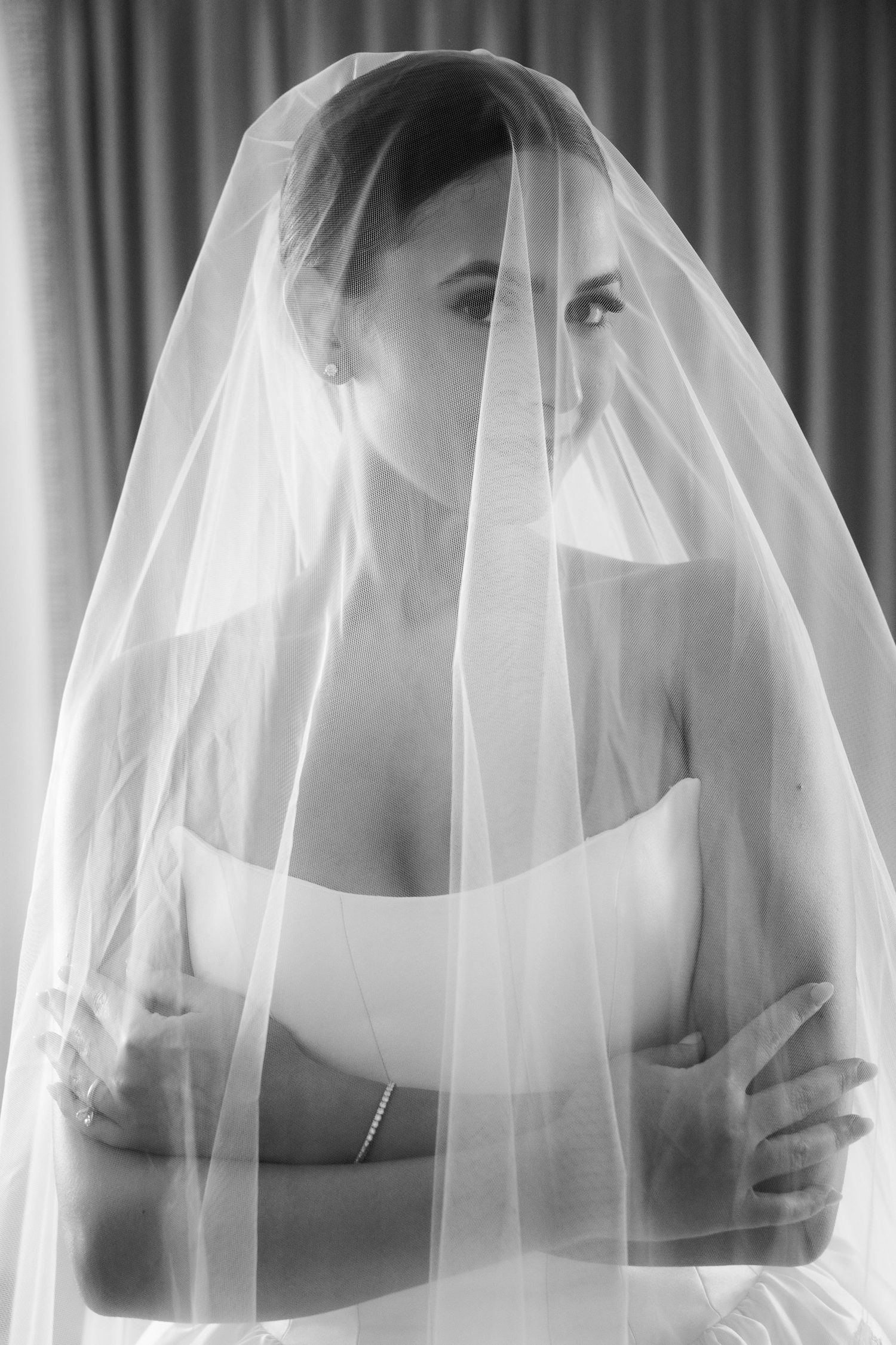 Artistic series of bridal portraits through sheer white veil showing elegant silhouettes against light background.