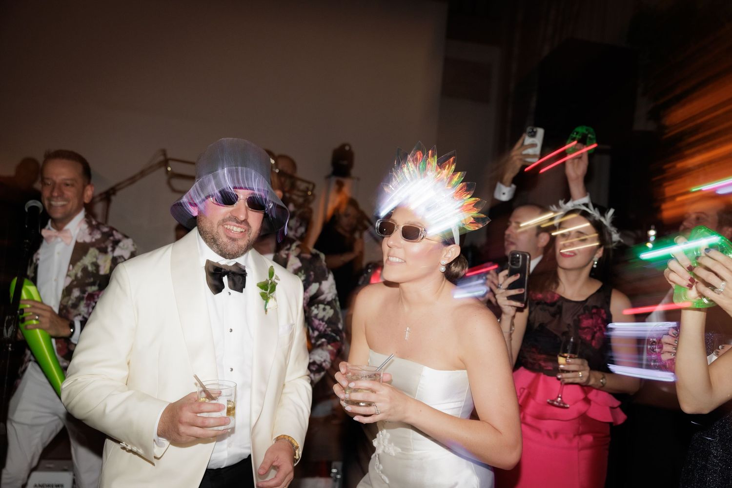 Wedding reception guests dancing and celebrating on the dance floor during a festive party.