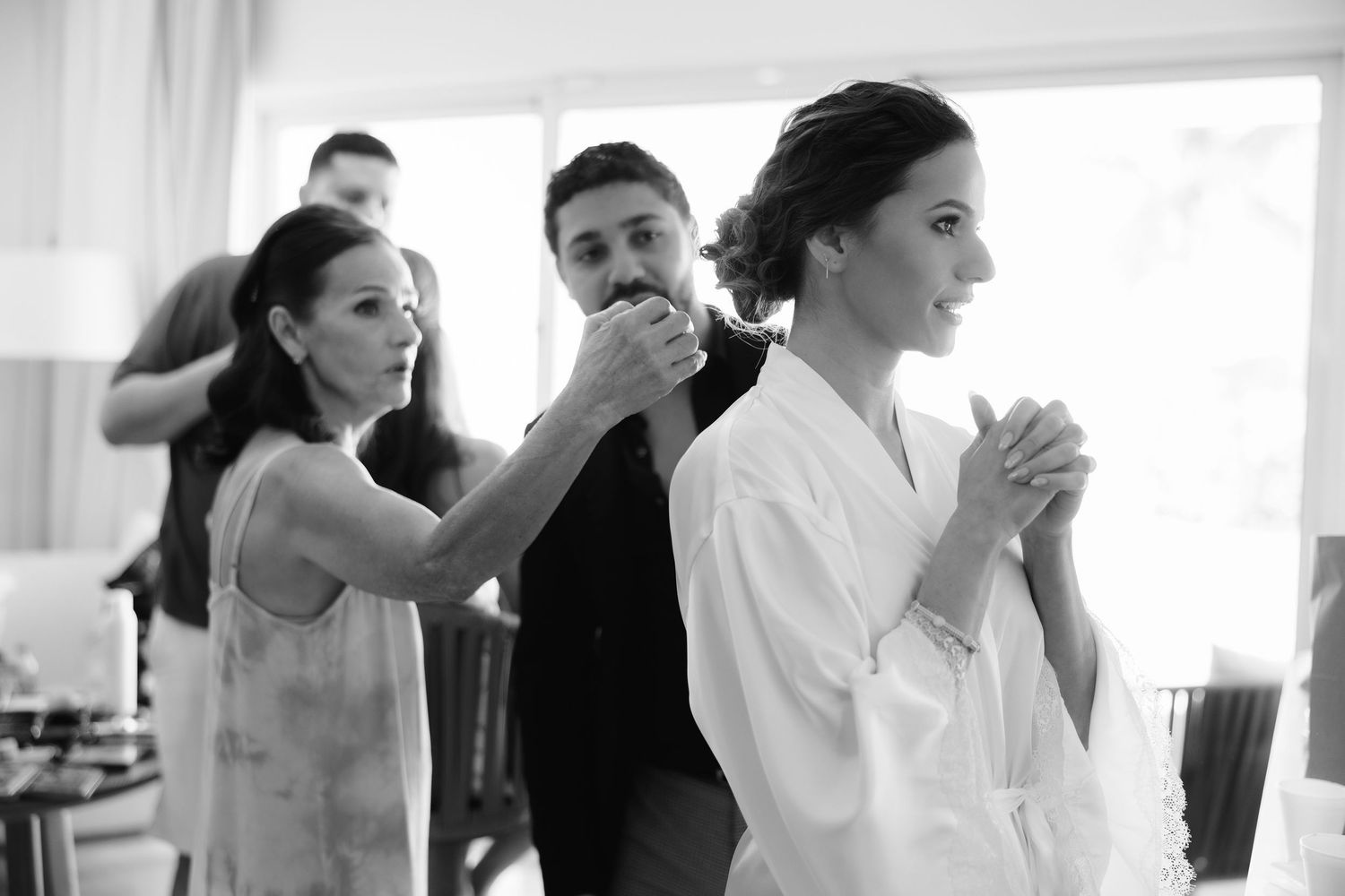 Couples dancing together during wedding reception ballroom dance lessons on light hardwood floors.