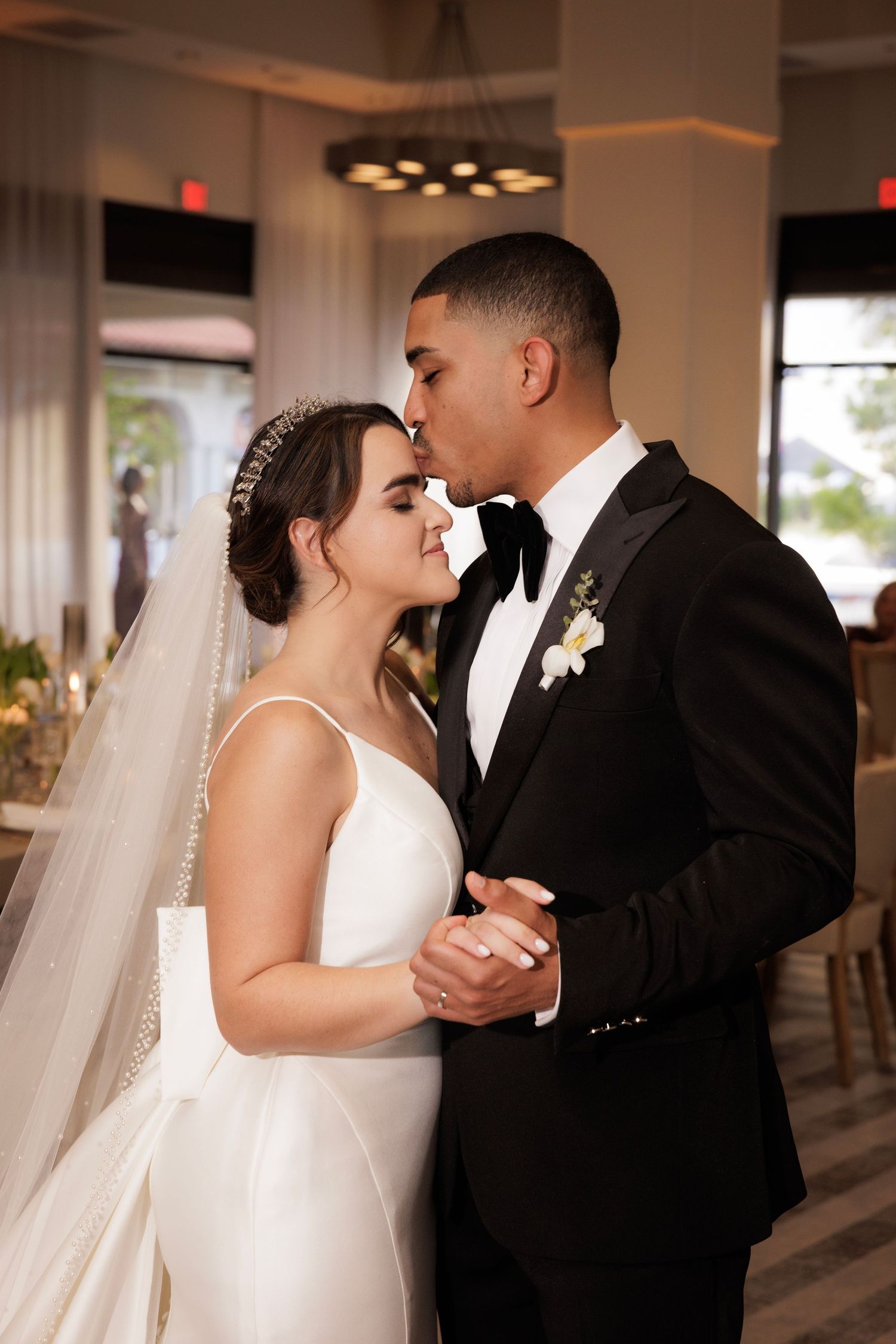 Series of romantic wedding moments showing a couple's first dance in a reception venue with warm lighting.