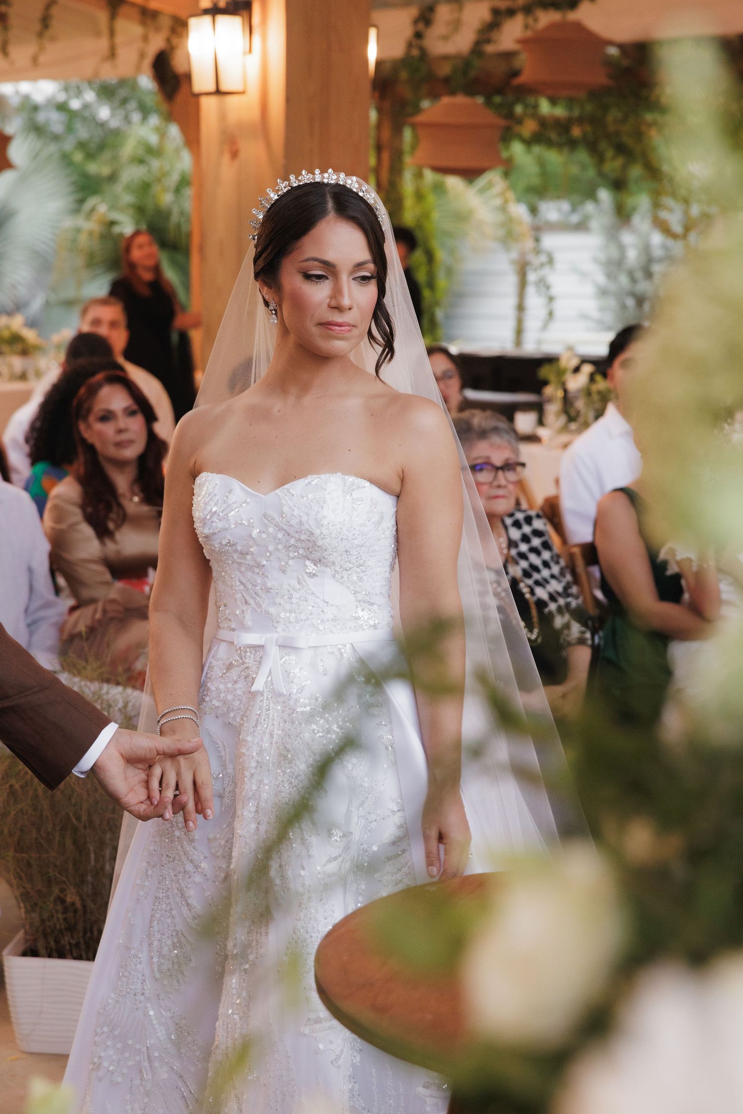 Close-up details of an elegant lace wedding dress with delicate beading and embellishments.