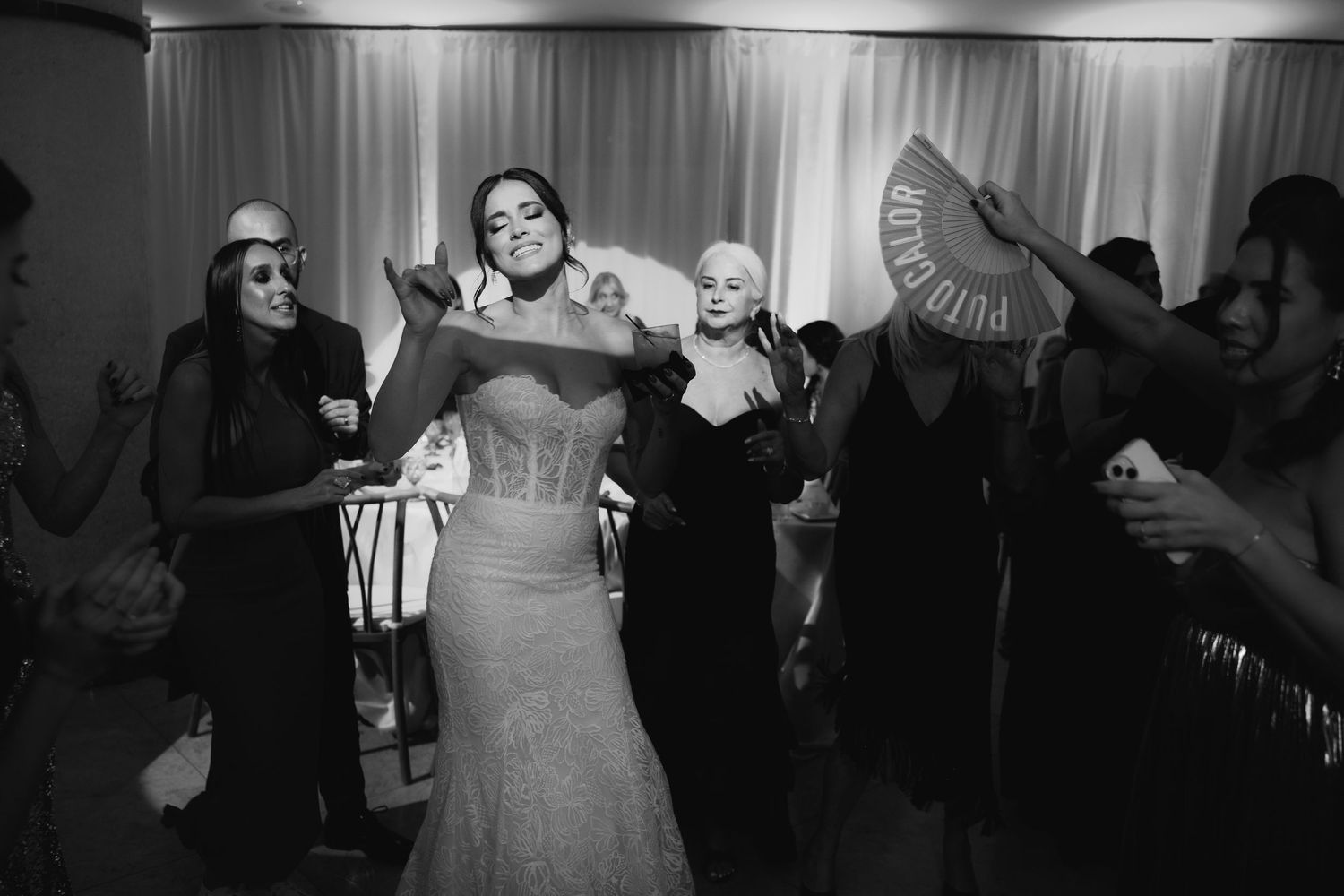 Black and white photographs of a wedding reception show guests dancing and celebrating on the dance floor.