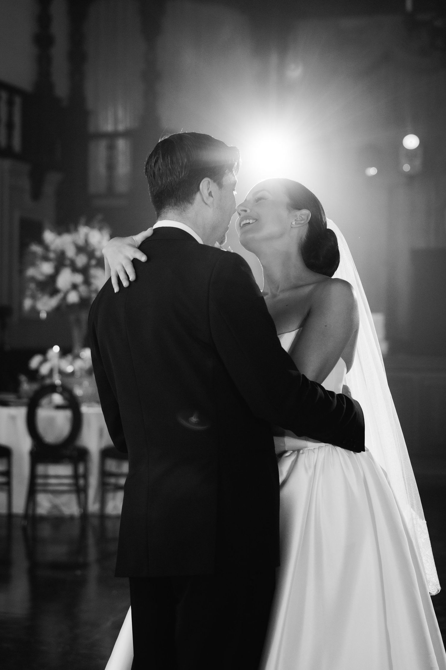 A series of intimate black and white wedding dance photos captured in dramatic lighting.