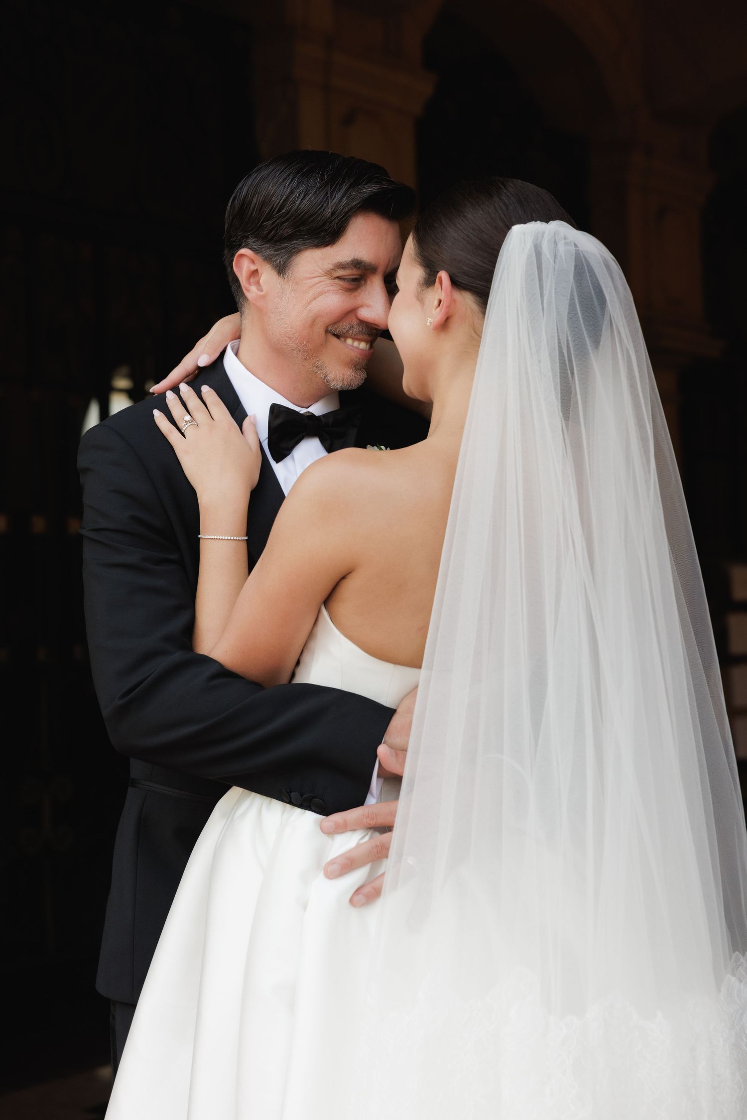 A sequence of intimate black and white wedding photos showing tender moments between newlyweds.