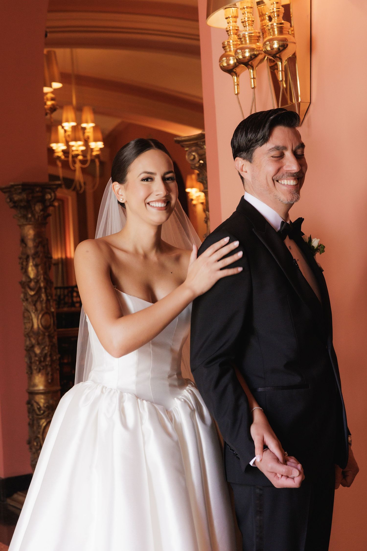 A series of first look photos showing a bride in white dress and groom in black suit in an elegant indoor setting.
