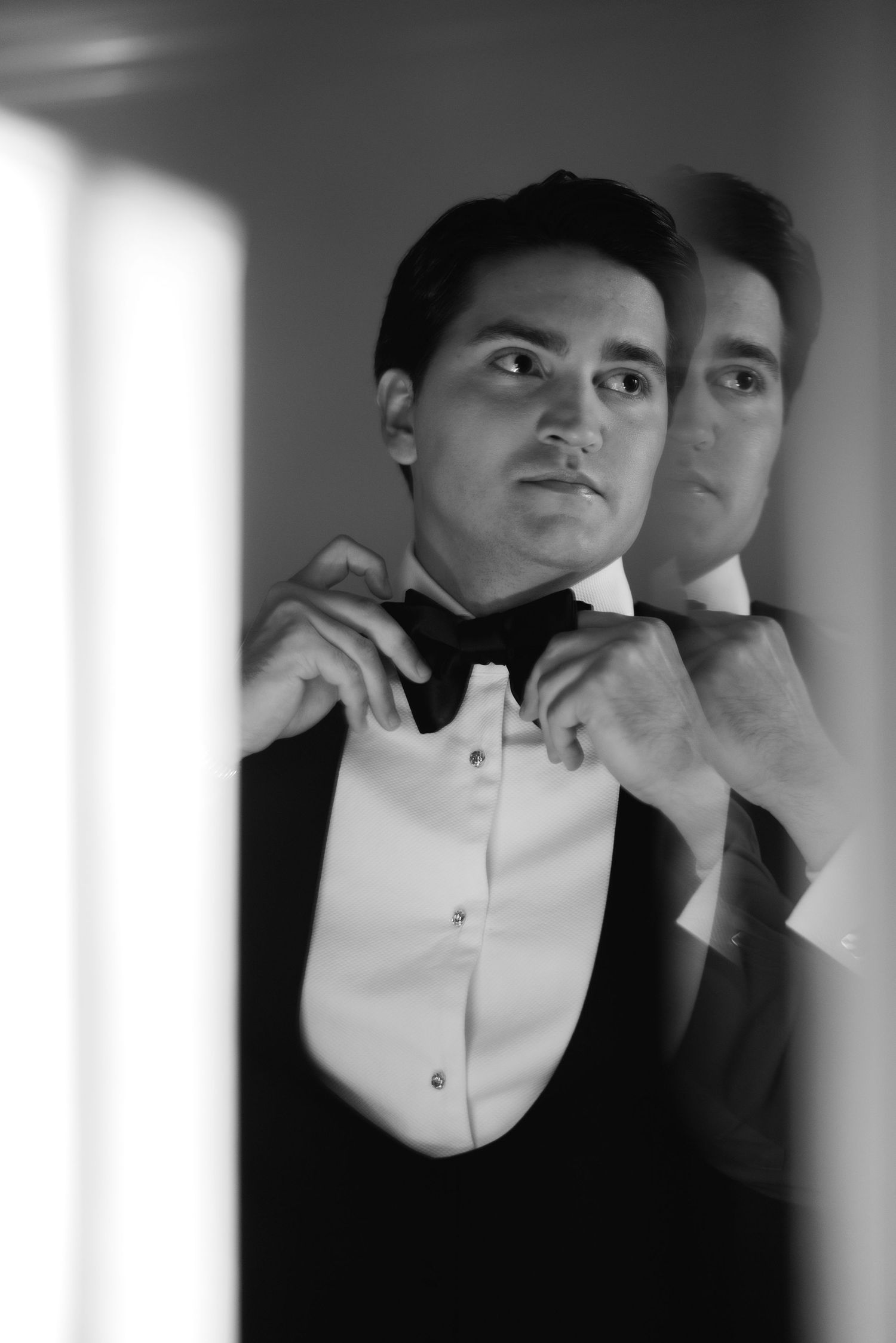 Artistic black and white portrait with overlapping shadows creating surreal double exposure effect.
