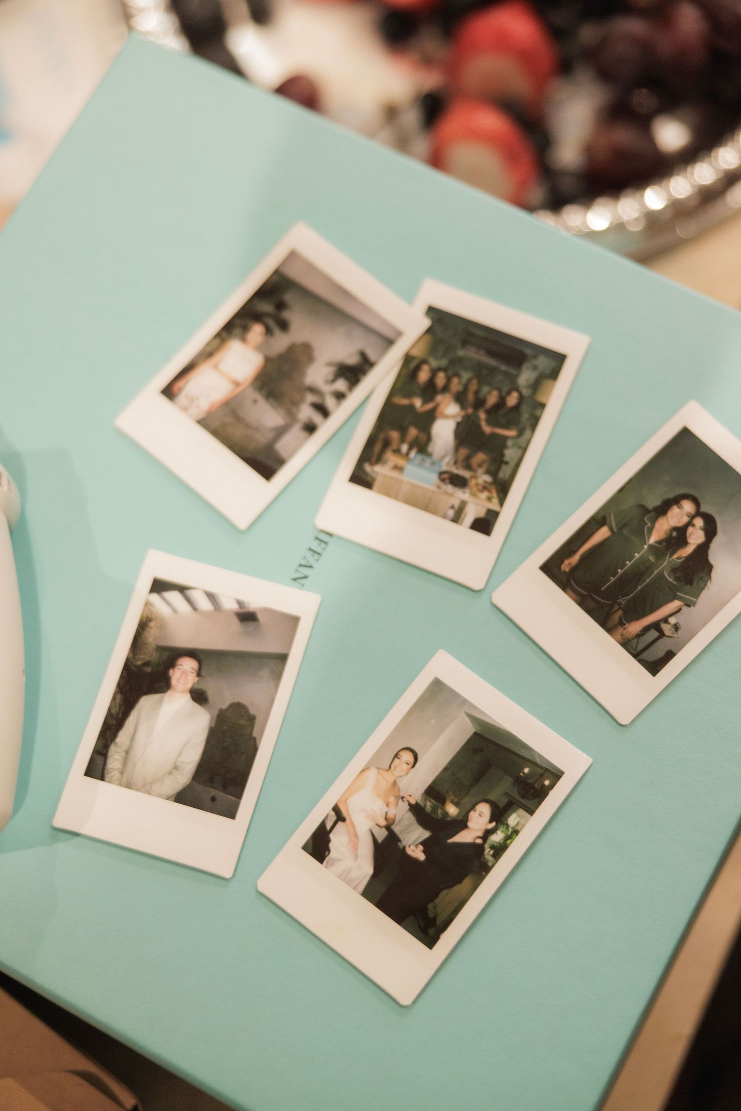 Vintage Polaroid photographs arranged on a light blue background.