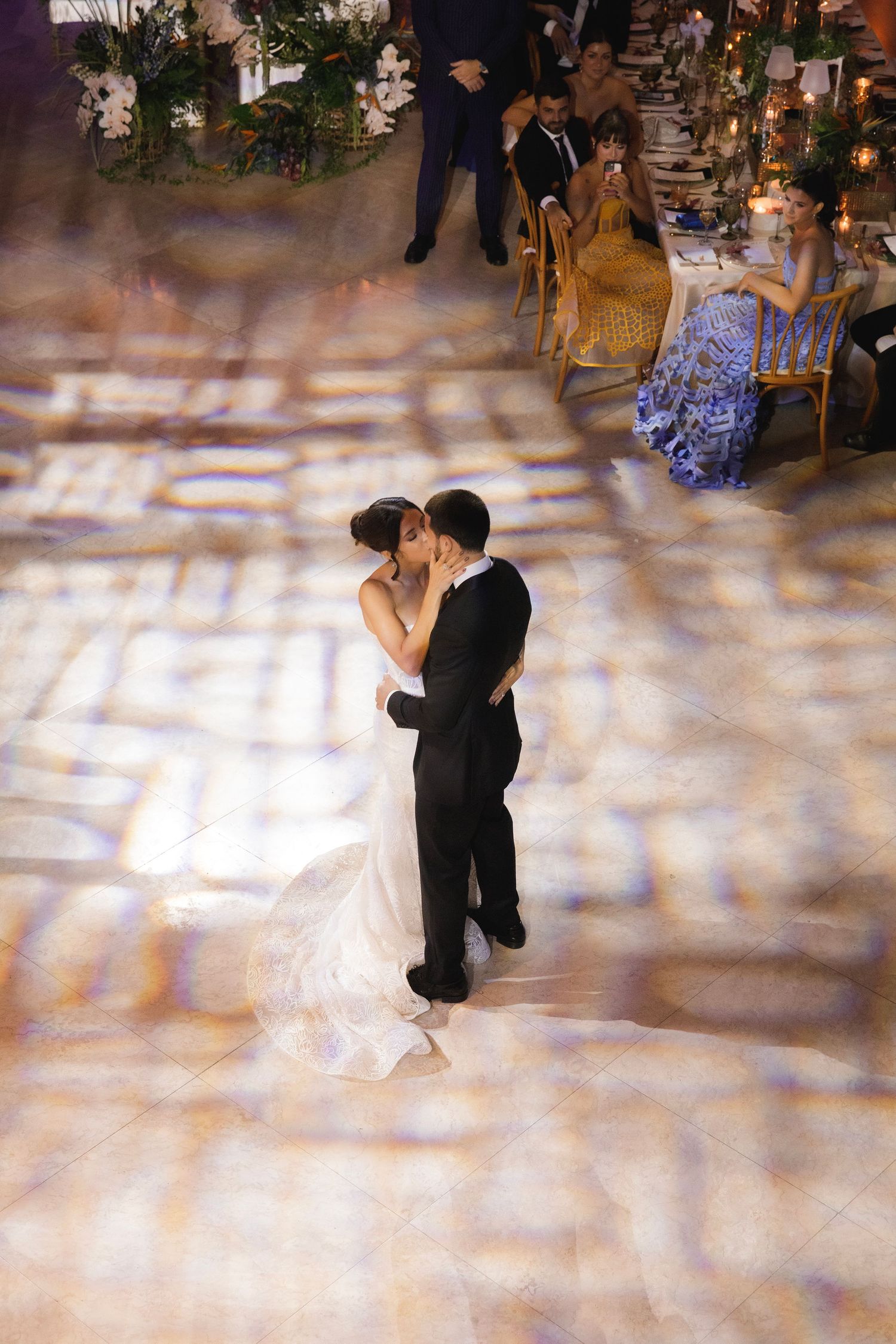 Two dancers perform an elegant ballroom dance sequence on a polished dance floor.