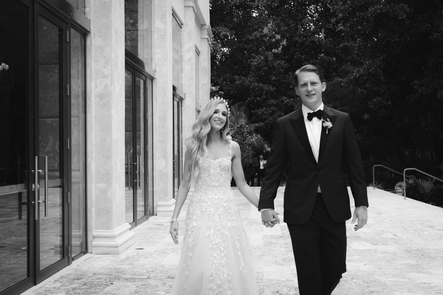 A romantic black and white montage of wedding photos showing a bride and groom walking together in formal attire.