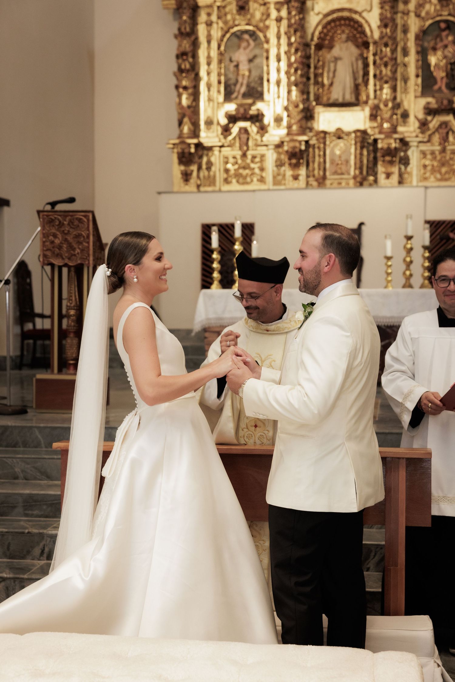 A sequence of dance moves between a couple in formal wedding attire inside an ornate church setting.