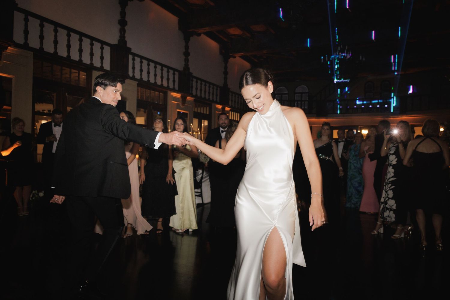 Wedding reception dance floor with dramatic lighting and festive atmosphere.