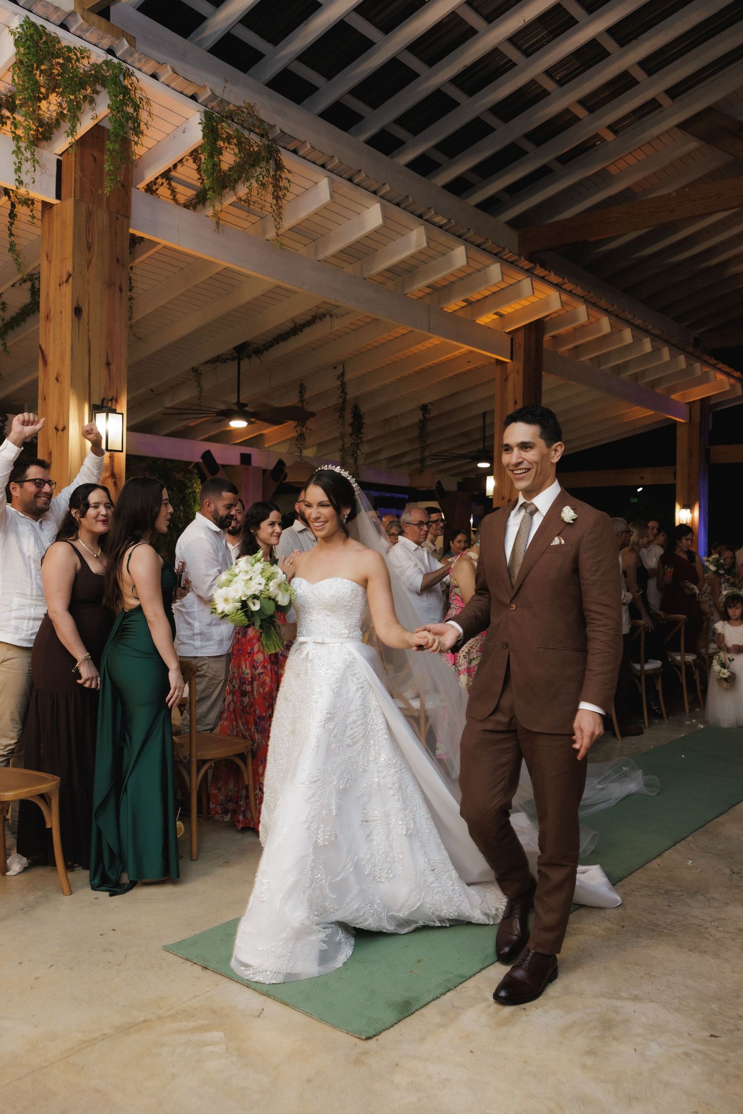 A wedding celebration in a rustic venue with wooden beams and elegant lighting.