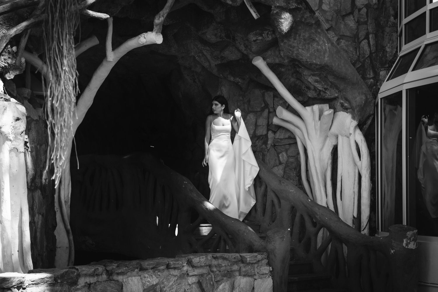 A black and white outdoor party scene with string lights hanging above the dance floor at night.