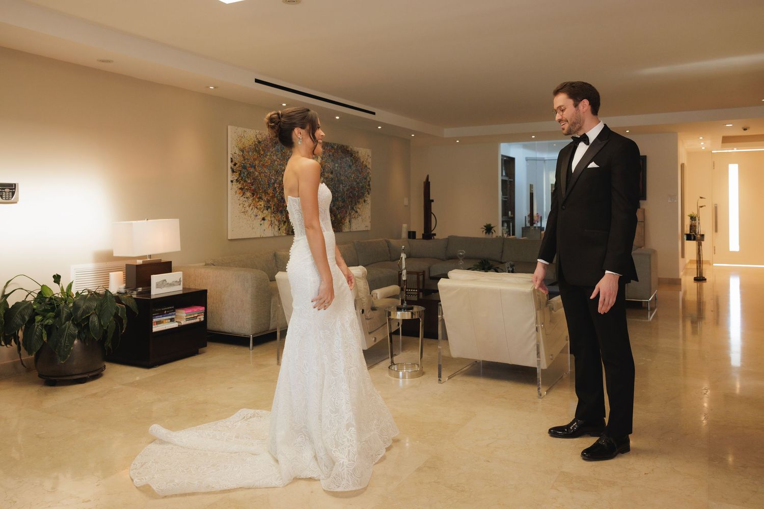Wedding preparations in an elegant cream-colored room with modern decor.