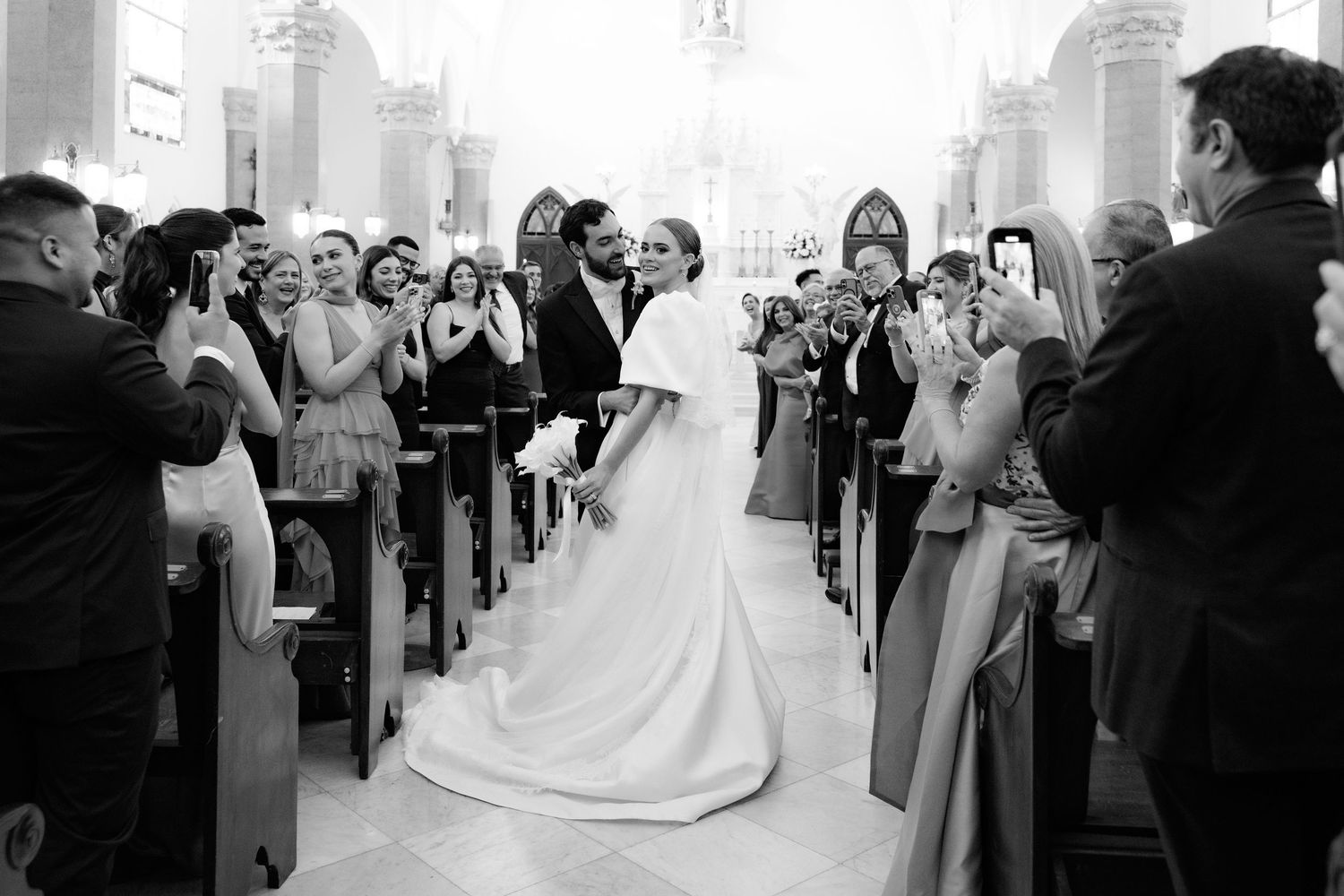 Wedding ceremony guests line up to congratulate the newlyweds in five sequential candid photos.