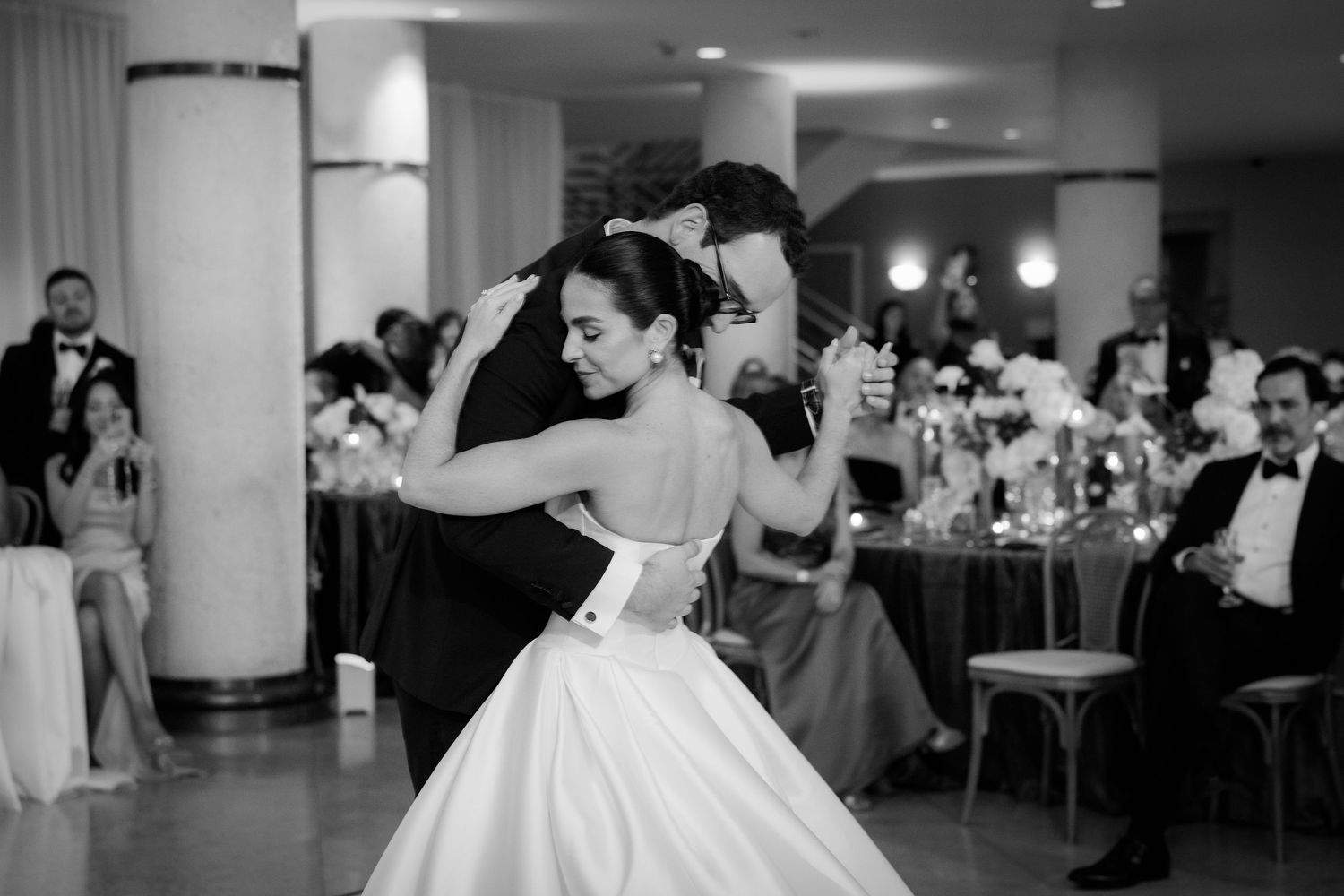 A black and white collage of wedding reception moments showing dancing, dining and celebration at an elegant venue.