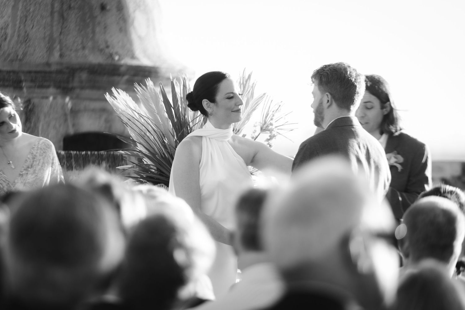 Black and white candid photo of wedding reception crowd.