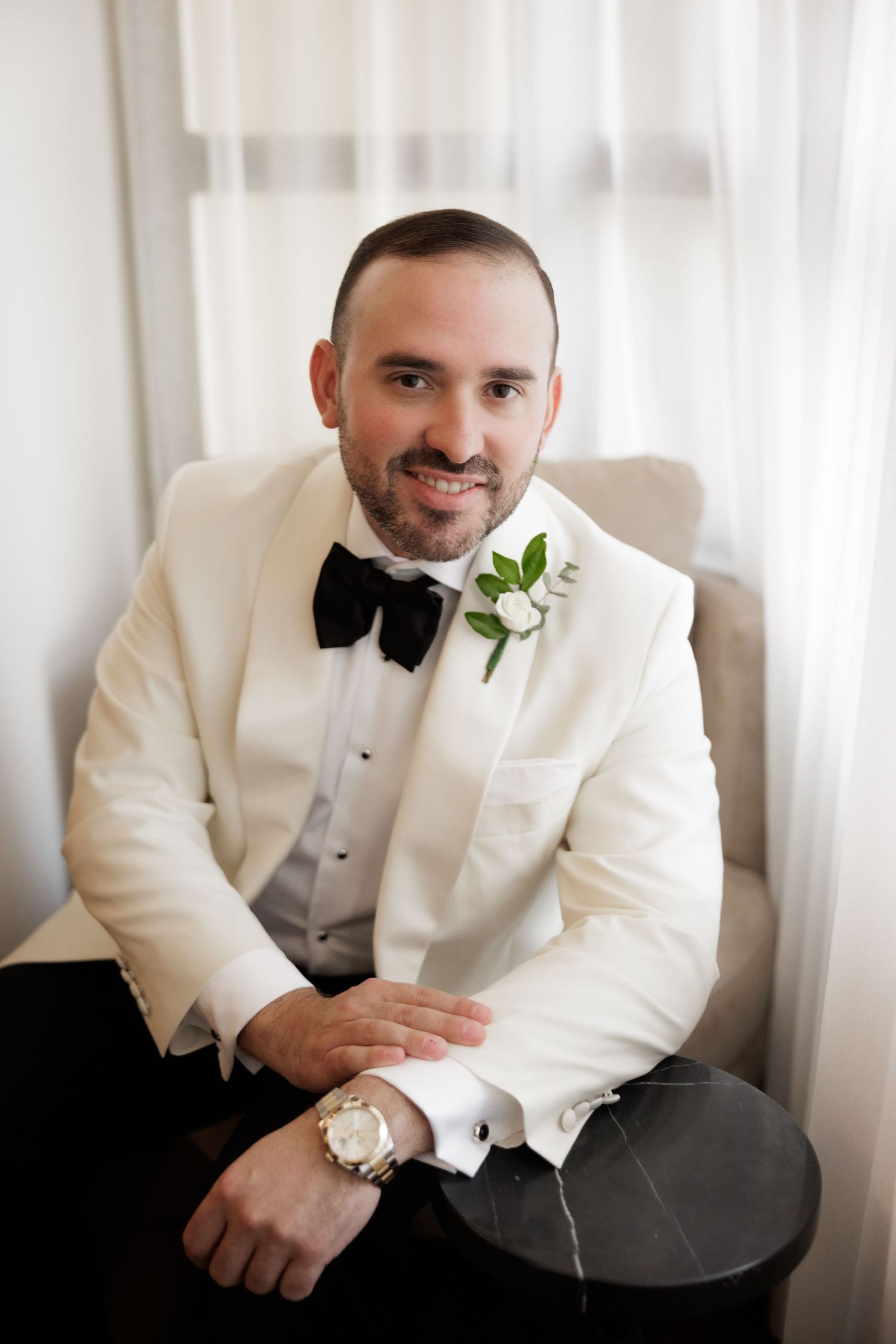A series of color photos showing someone in a white dinner jacket with a black bow tie.