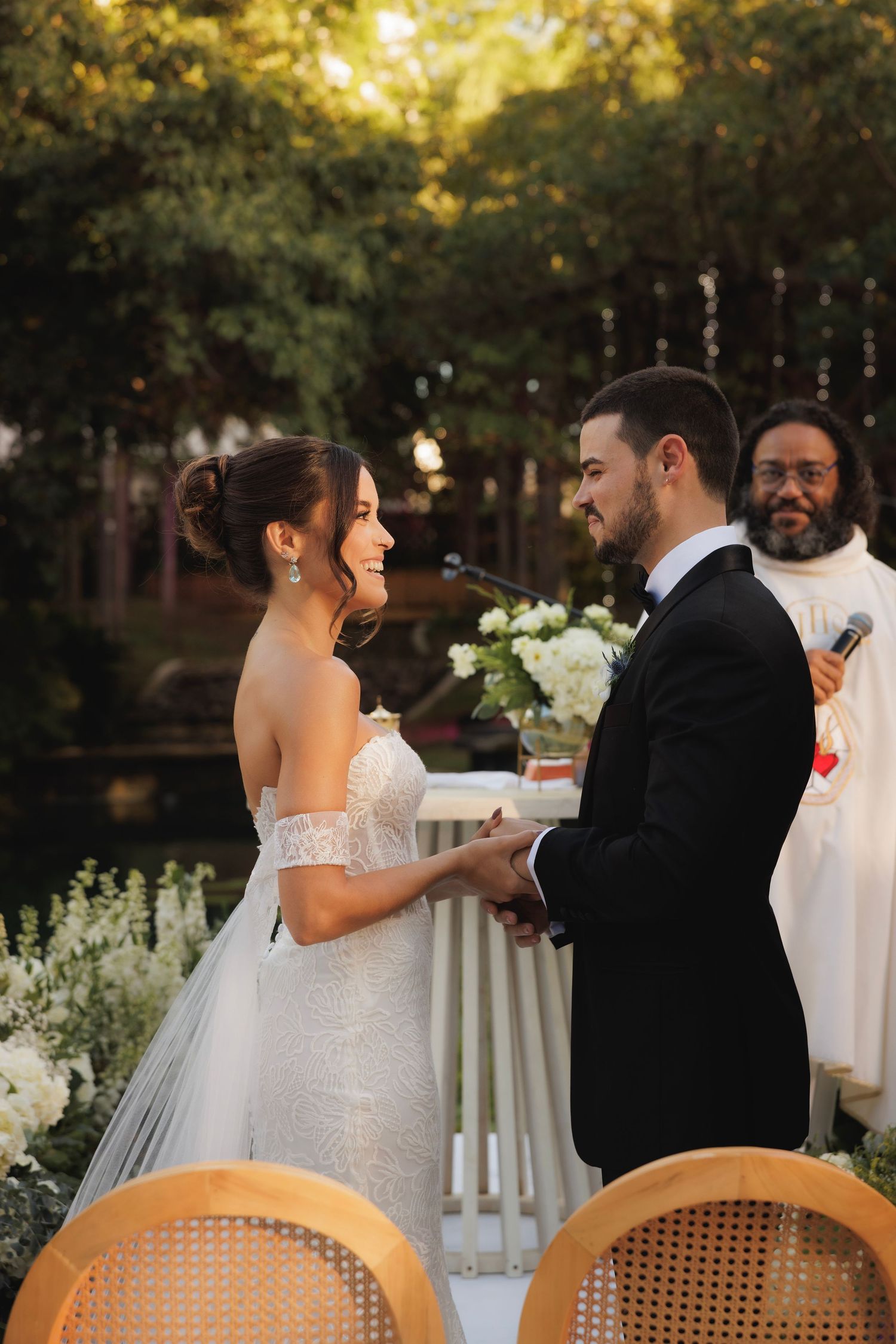 Intimate wedding ceremony moment captured during golden hour in a lush garden setting.