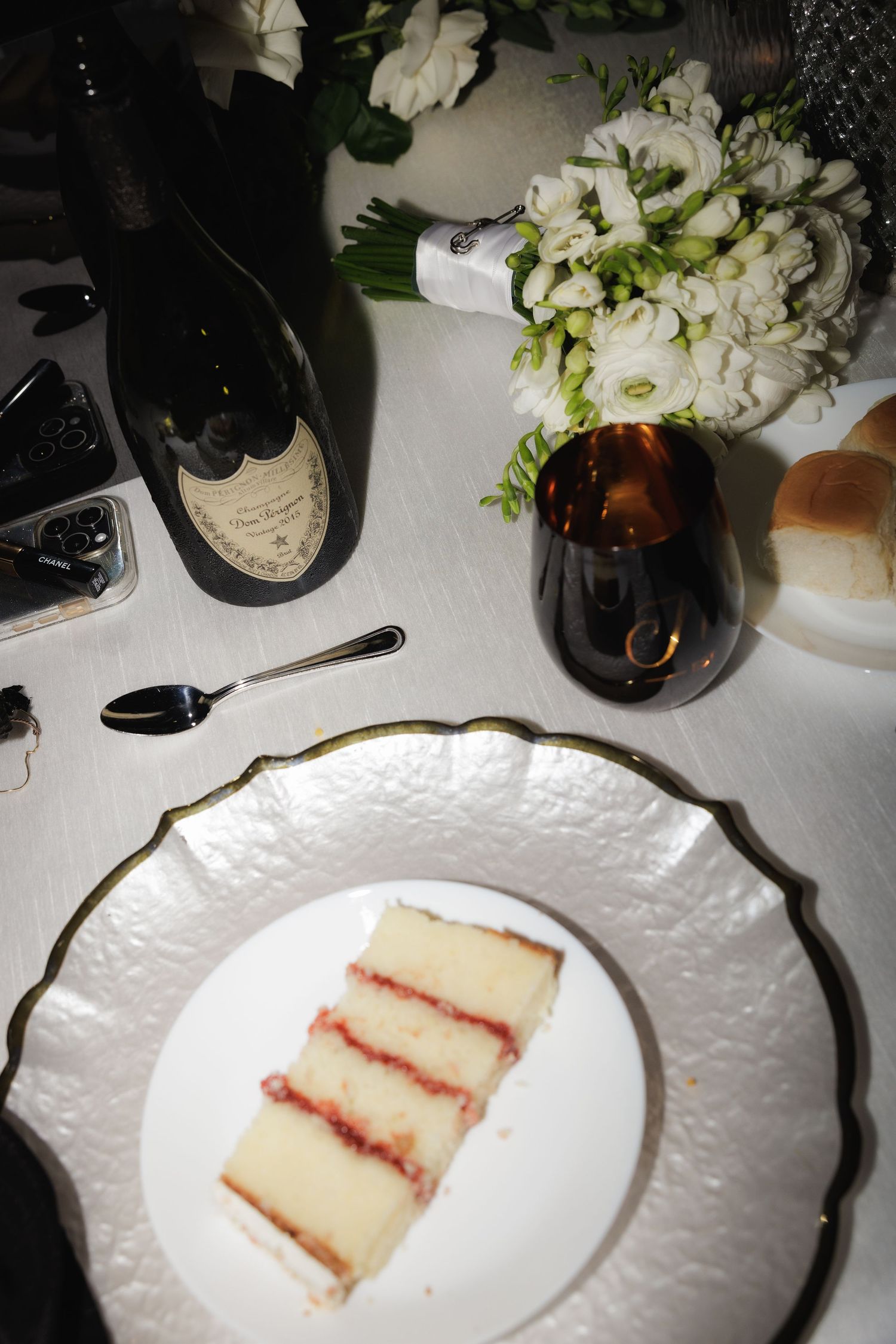 Four white plates display slices of layered vanilla cake with red filling arranged in a sequence.