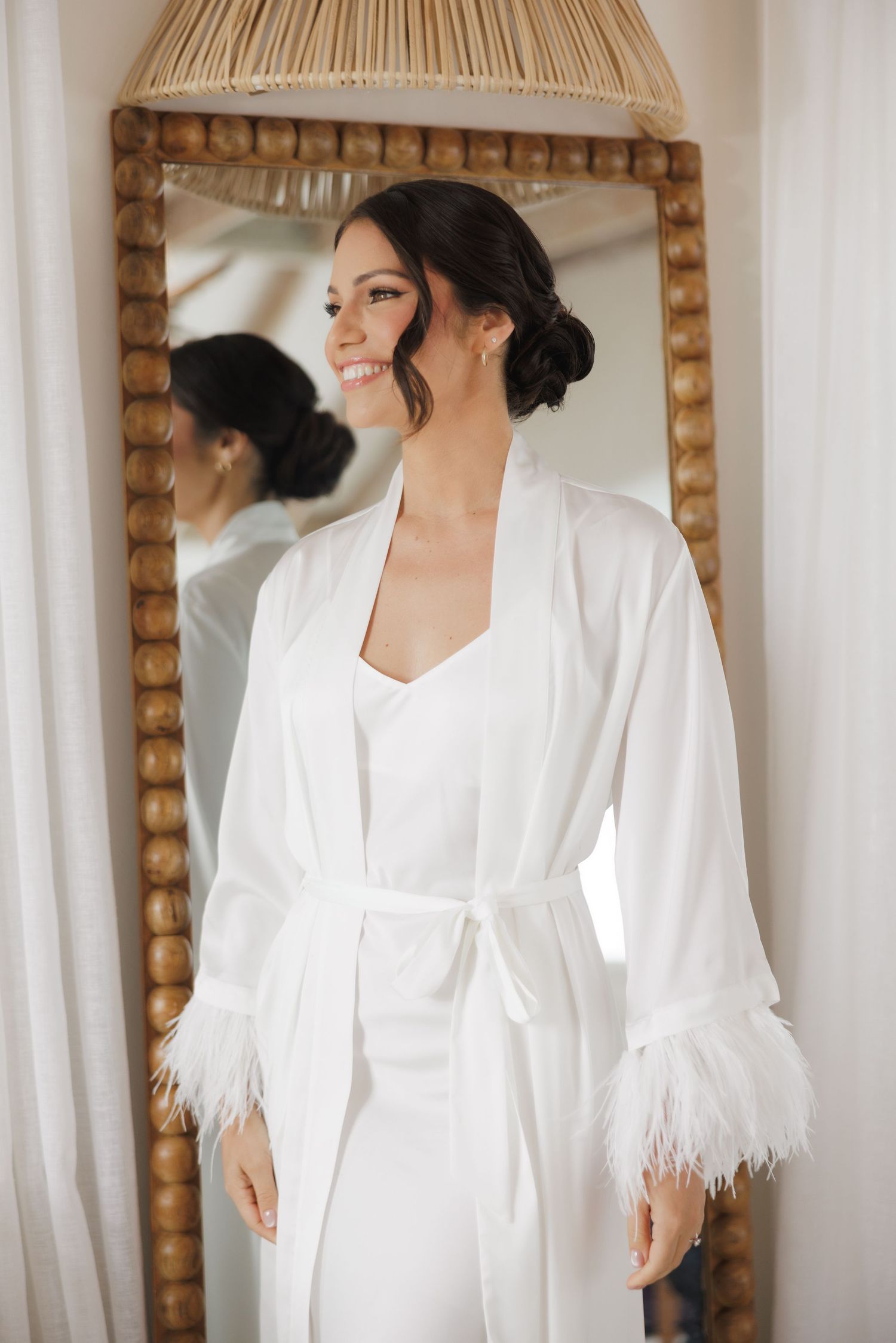 Stylish white feathered robe captured in a mirror reflection with natural lighting.
