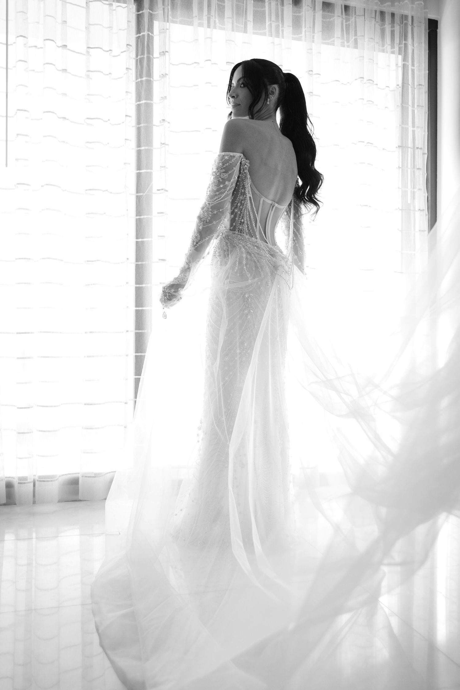 Ethereal bridal silhouettes in flowing white gowns against bright windows create a dreamy, romantic atmosphere.