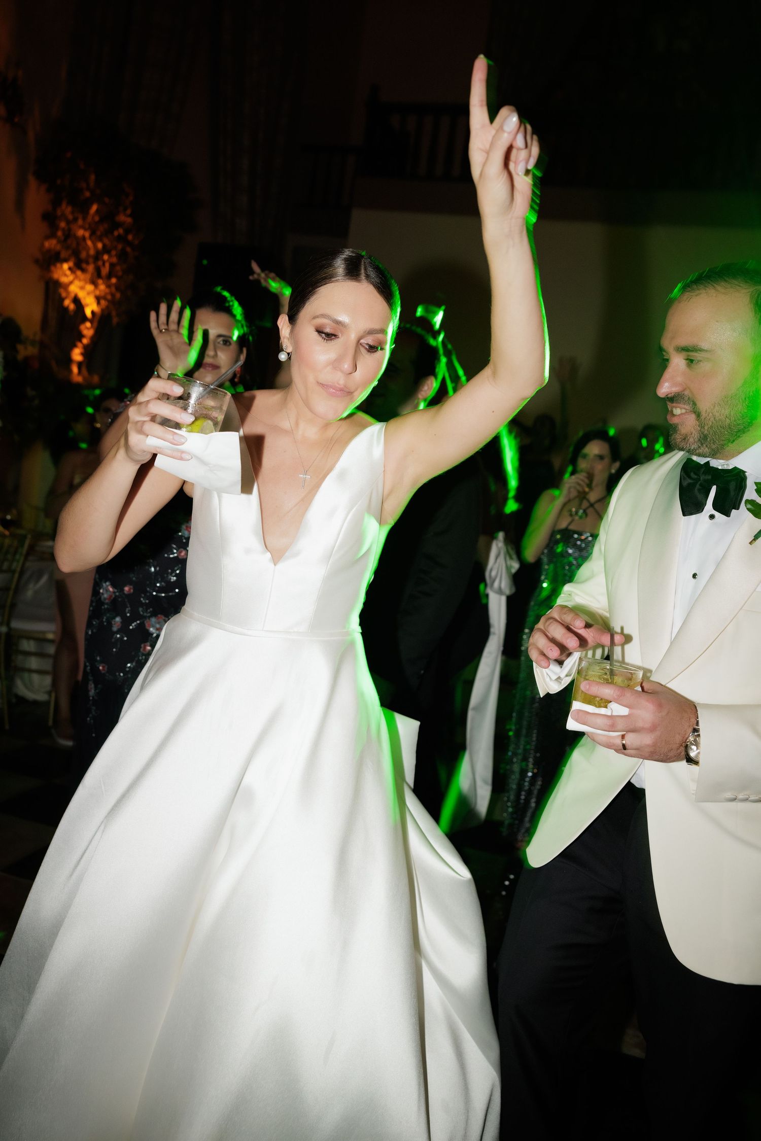 Wedding reception dance floor sequence showing bride in white dress dancing and celebrating with guests.