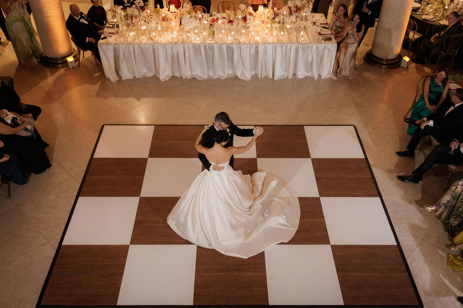 A sequence of dance floor photos showing a flowing white wedding dress moving across a black and white checkered floor.